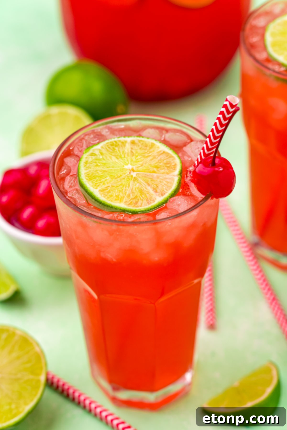 Front view of Cherry Limeade garnished with a lime and cherry.