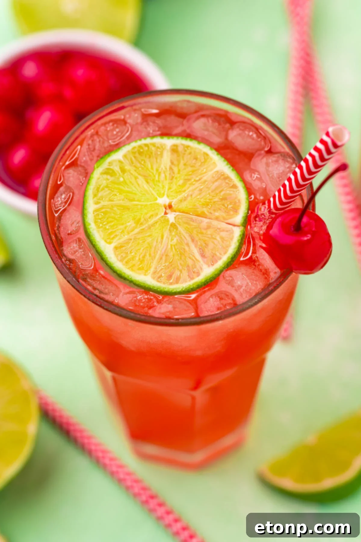 45 degree view of Cherry Limeade garnished with a lime and cherry.