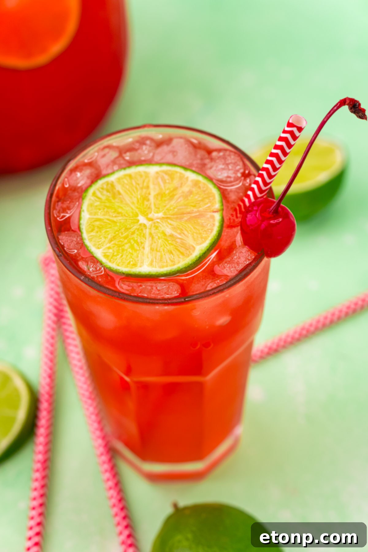 45 degree view of Cherry Limeade garnished with a lime and cherry.