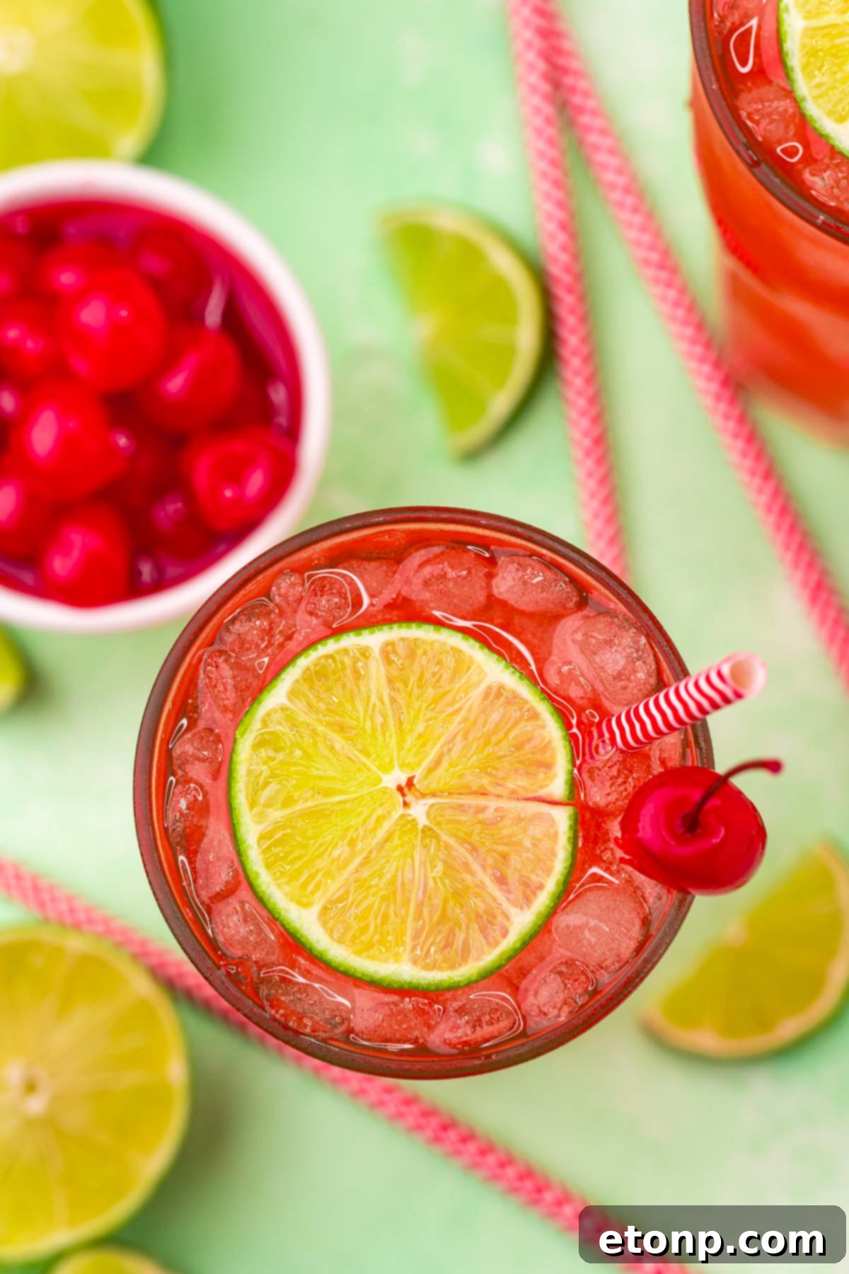 Overhead view of Cherry Limeade garnished with a lime and cherry.