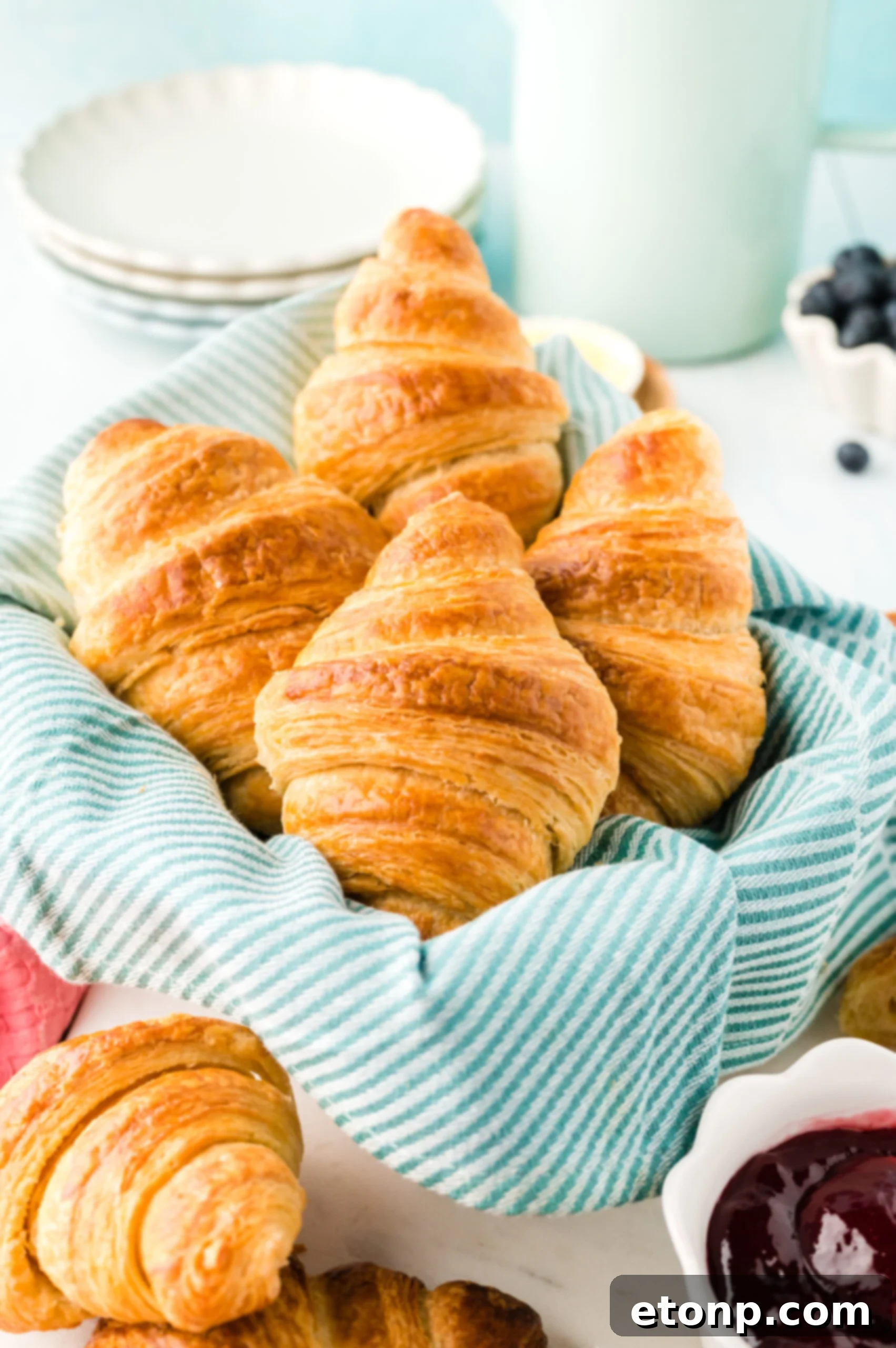 Front view of Homemade Croissants in a dish lined with linen. 