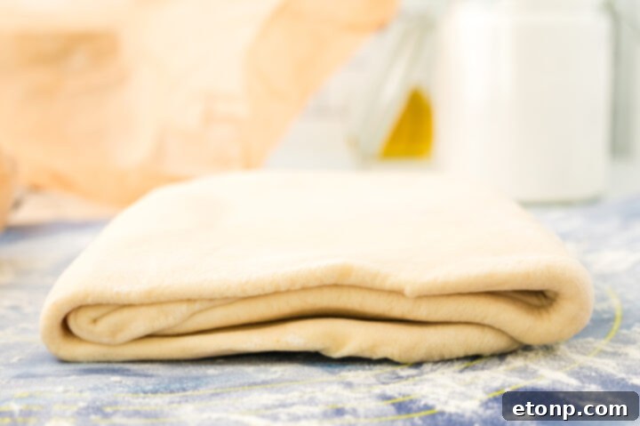 Croissant dough being folded for lamination