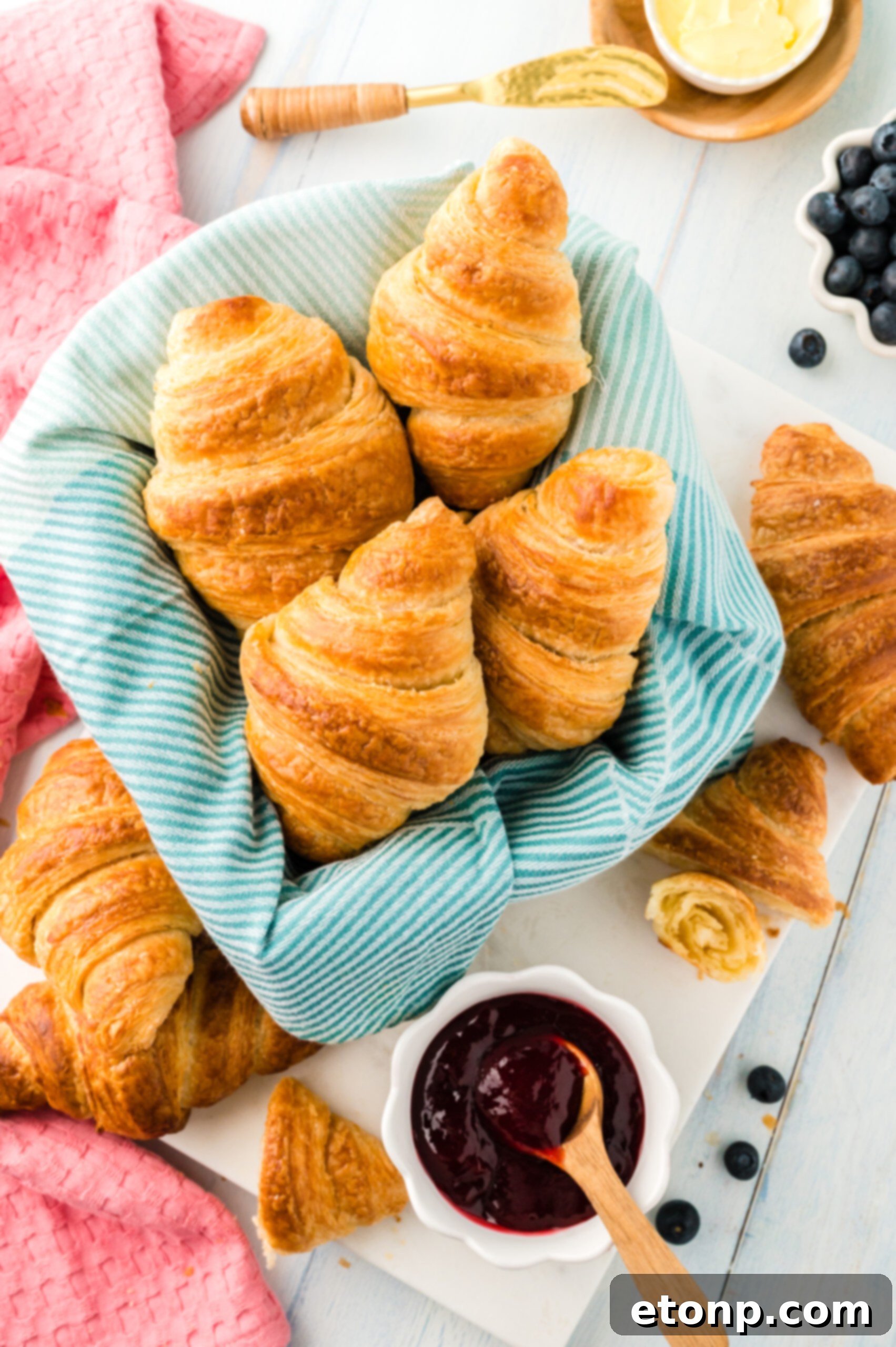 Overhead view of Homemade Croissants in a dish lined with linen.