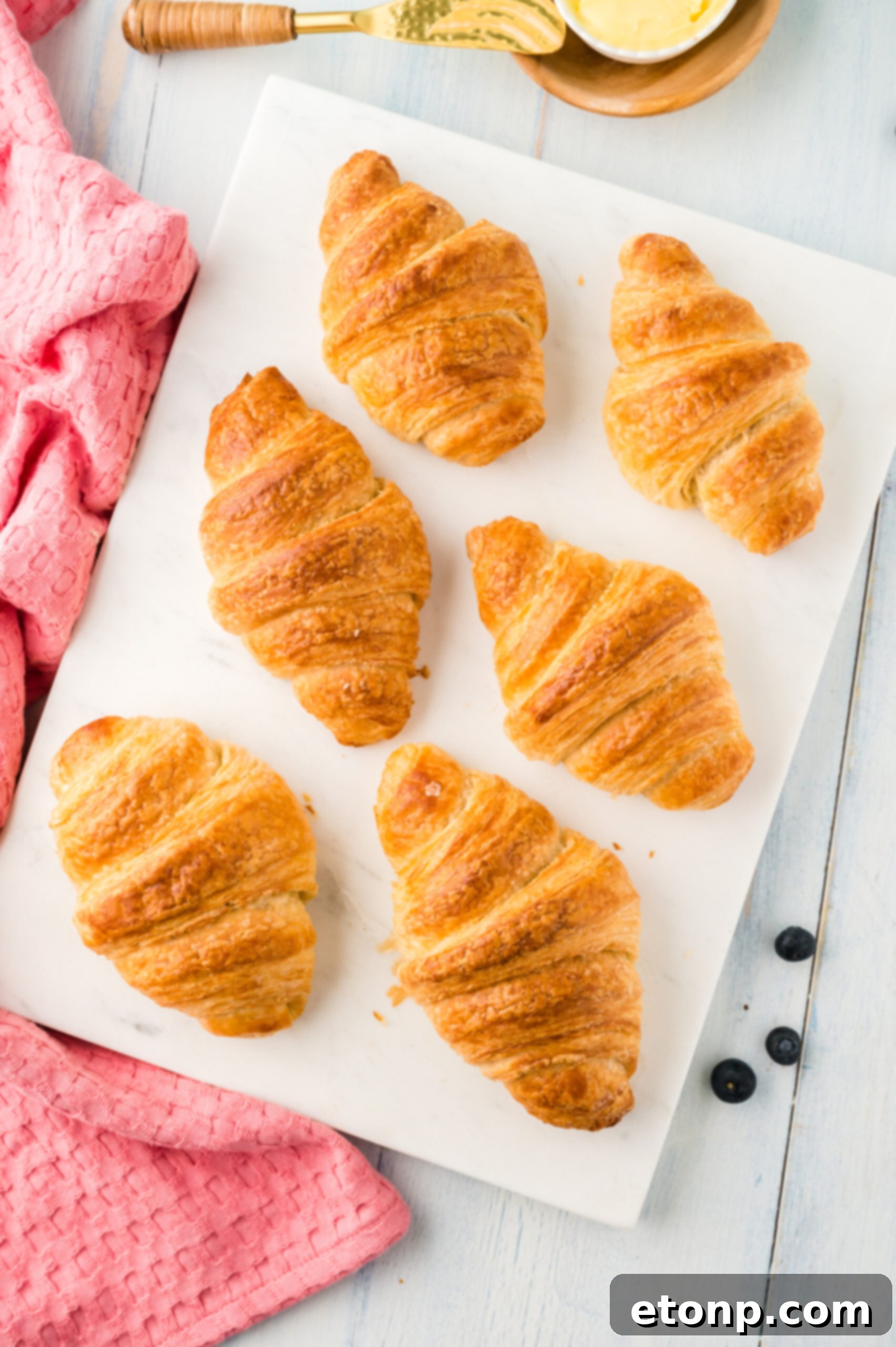 Overhead view of Homemade Croissants on a white serving dish.