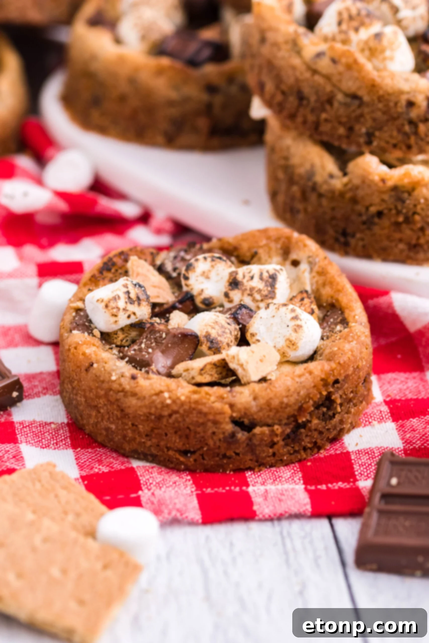 Front view of Deep Dish S’mores Cookies on red checkered linen.