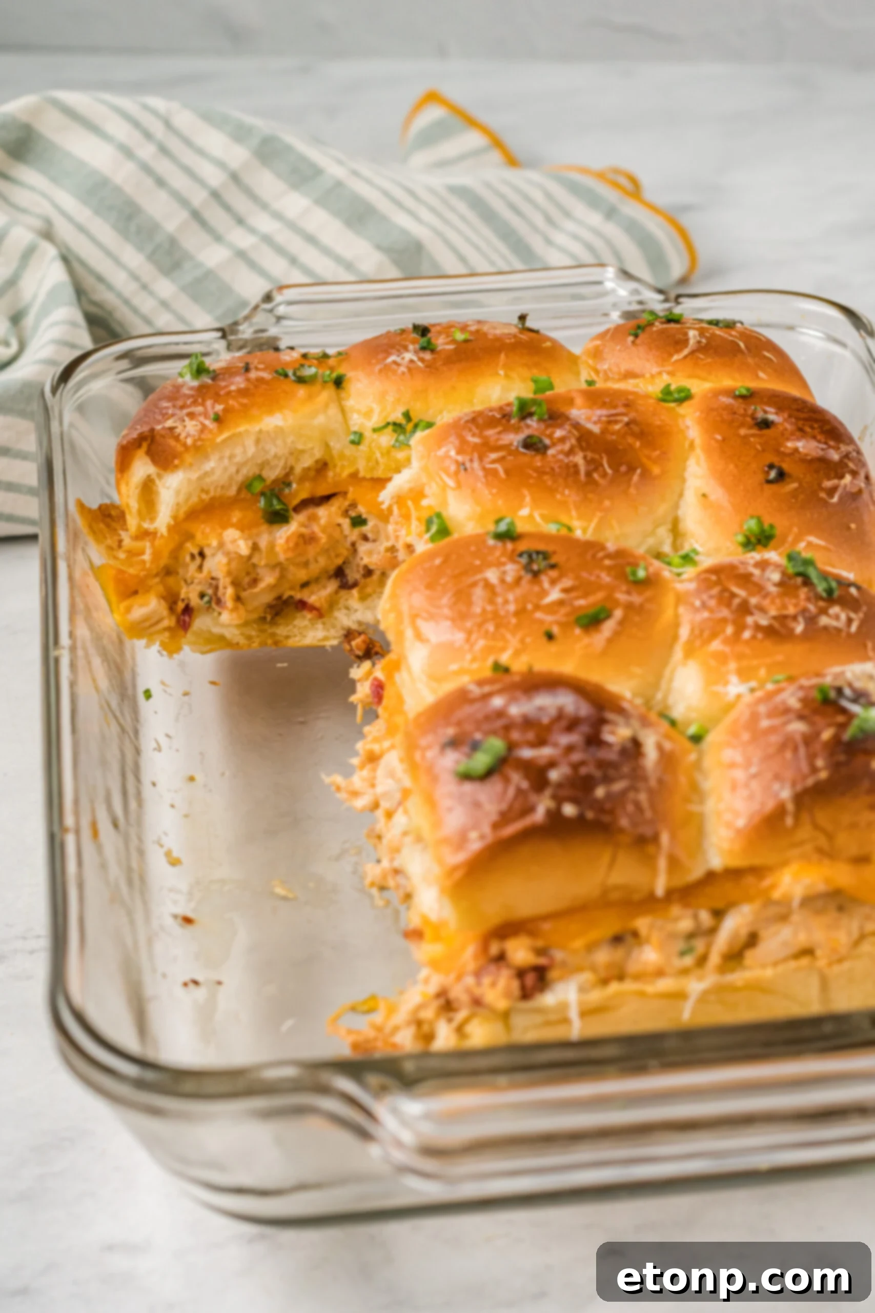 Front view of Crack Chicken Sliders in a clear baking dish.