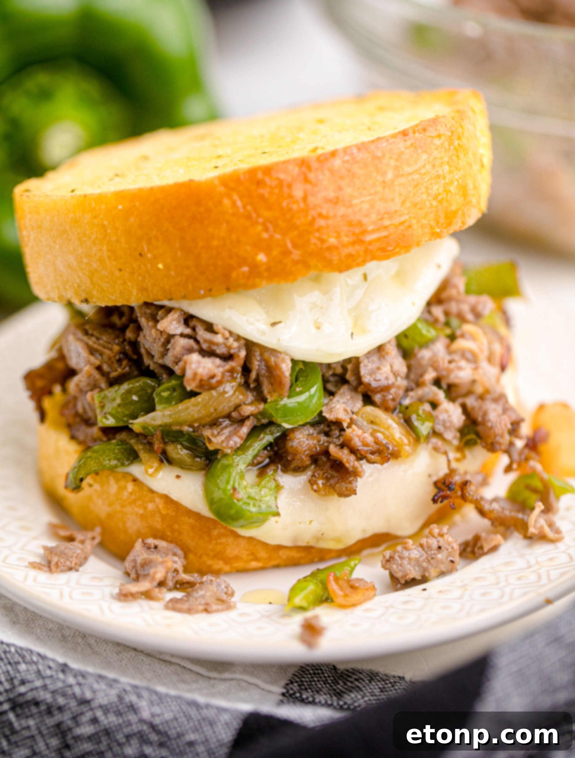 Crispy Air Fryer Philly Cheesesteaks 2 Front view of Air Fryer Philly Cheese Steaks on a white plate.