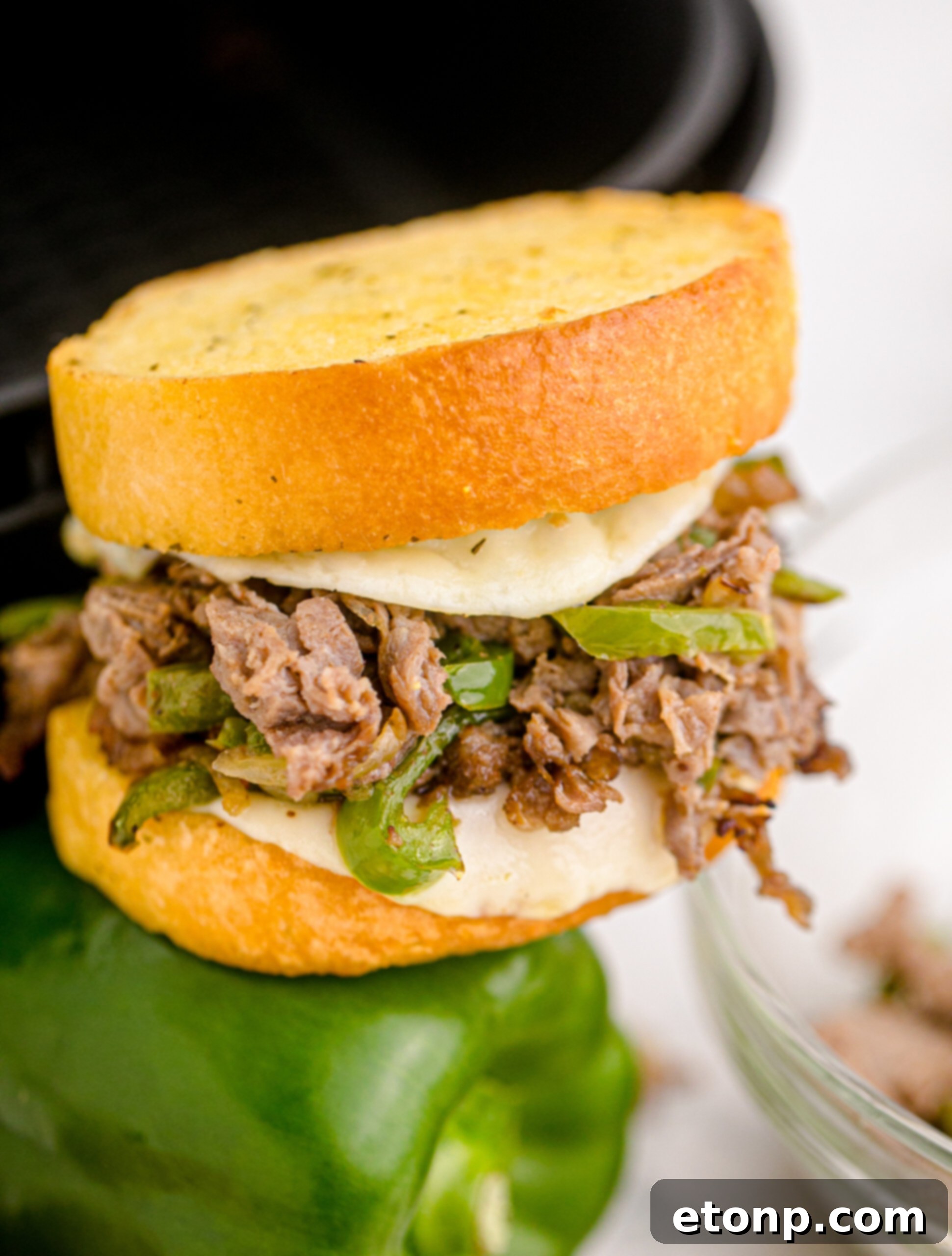 Crispy Air Fryer Philly Cheesesteaks 13 Front view of Air Fryer Philly Cheese Steaks green bell pepper.
