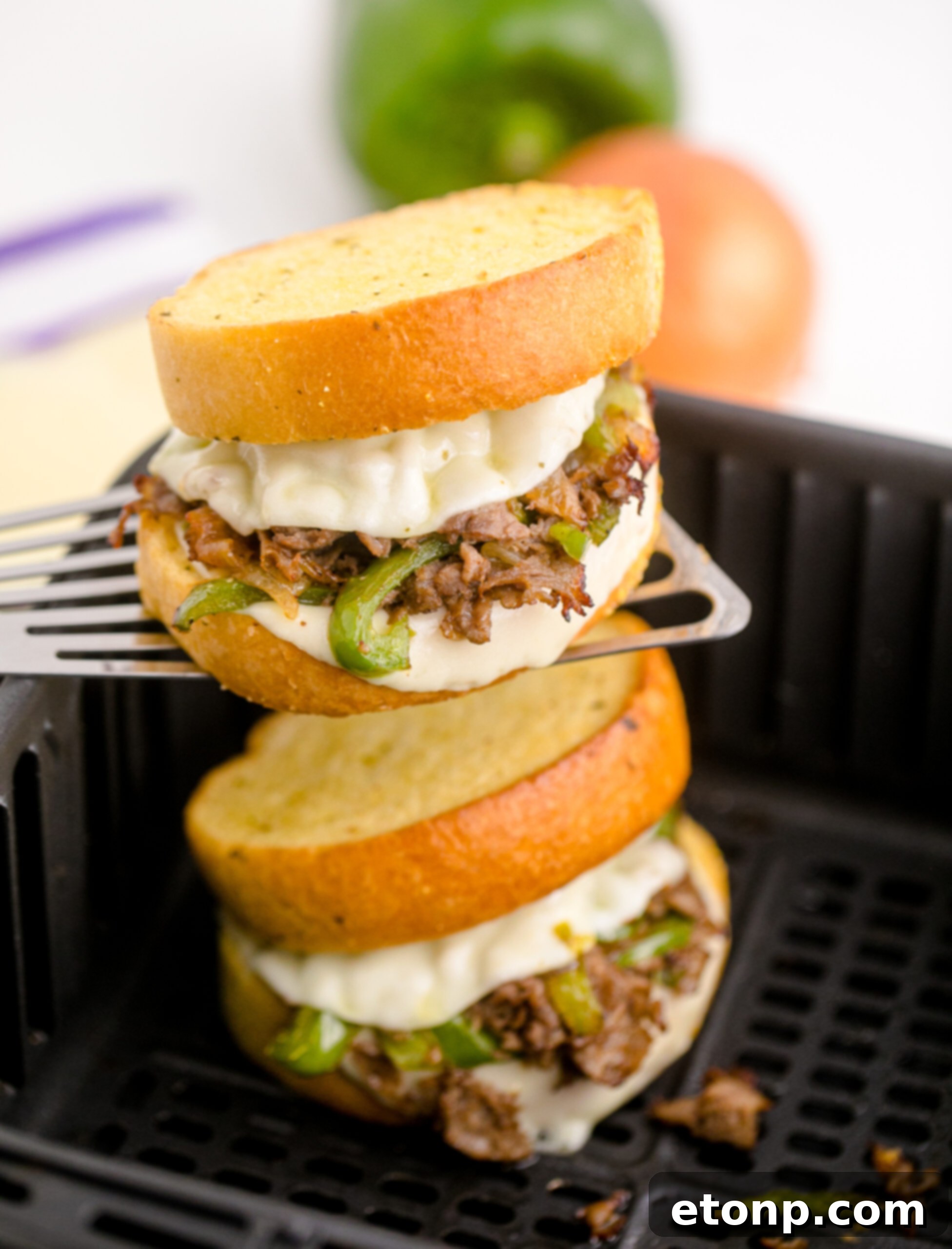 Crispy Air Fryer Philly Cheesesteaks 3 Front view of Air Fryer Philly Cheese Steaks On a silver spatula.