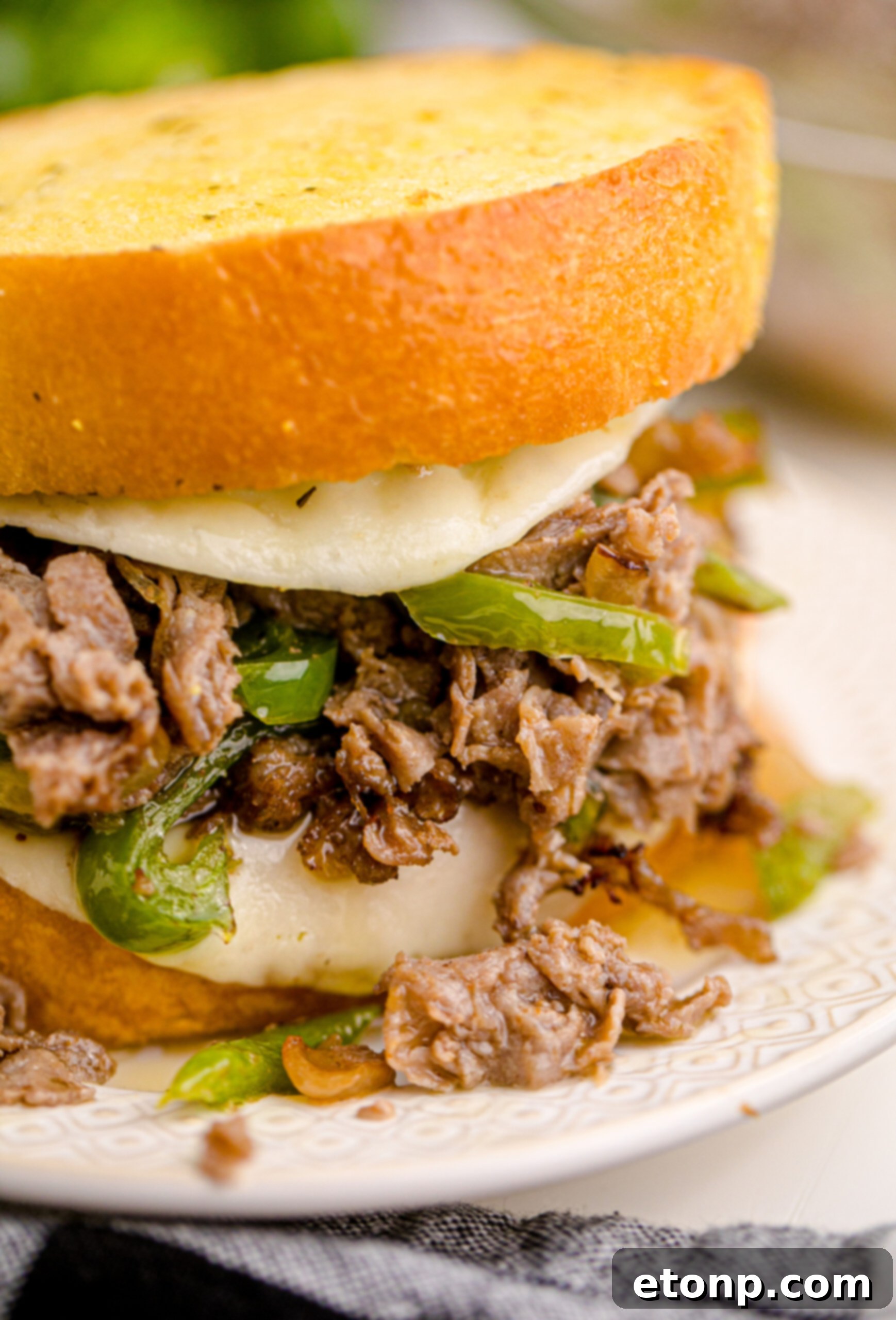 Crispy Air Fryer Philly Cheesesteaks 4 Up close view of Air Fryer Philly Cheese Steaks on a white plate.
