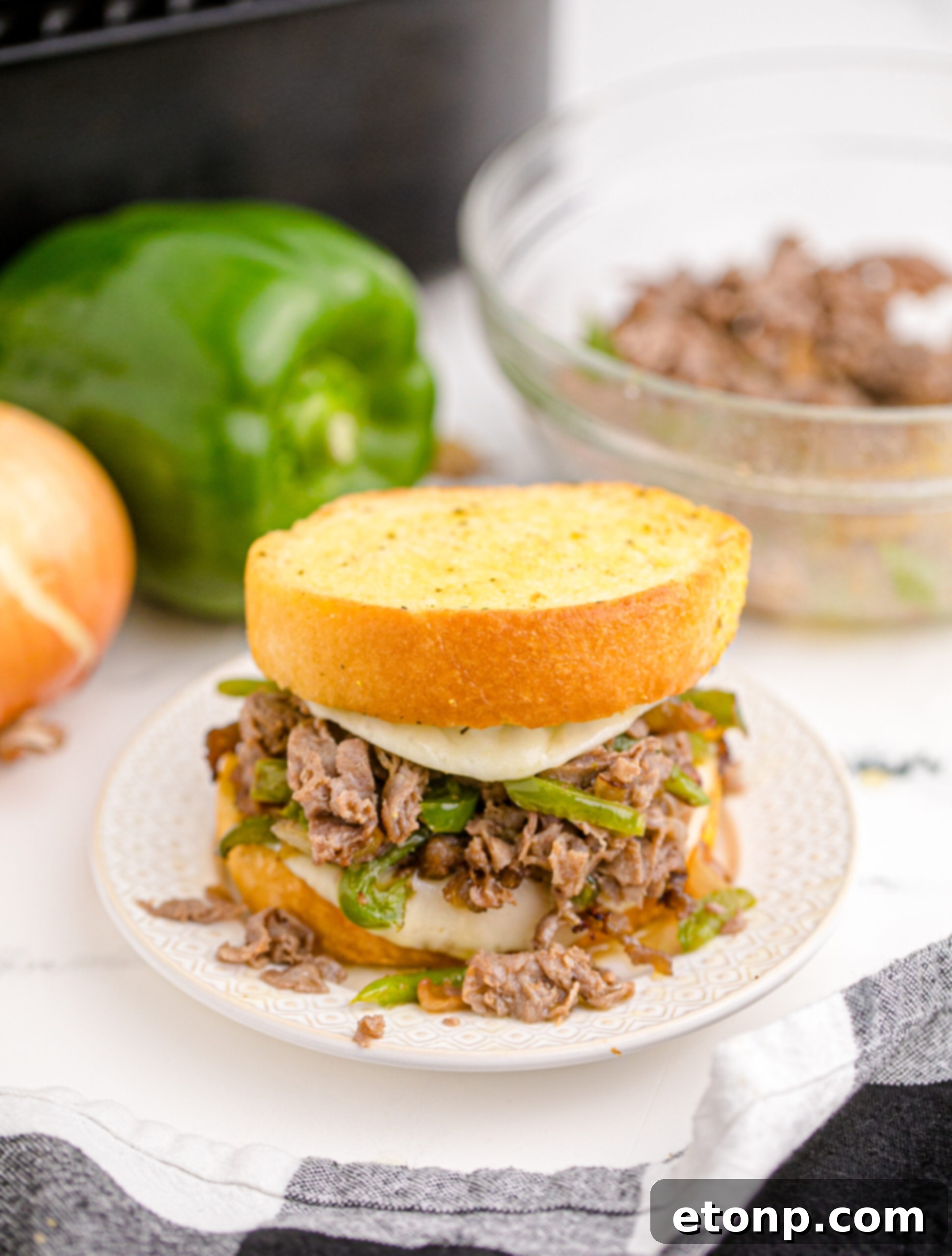 Crispy Air Fryer Philly Cheesesteaks 5 Front view of Air Fryer Philly Cheese Steaks on a white plate.