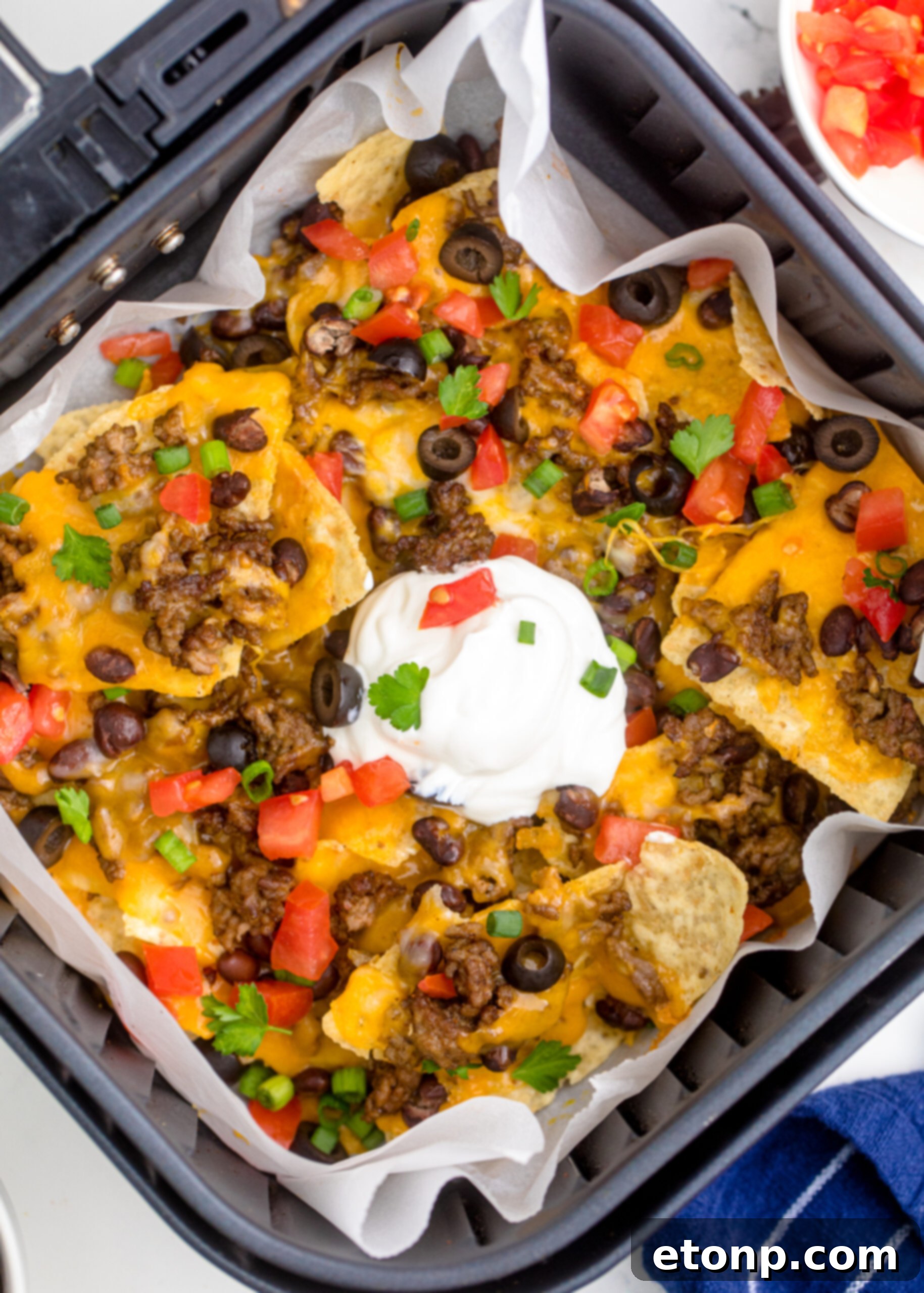 Overhead view of Air Fryer Nachos in an air fryer basket.