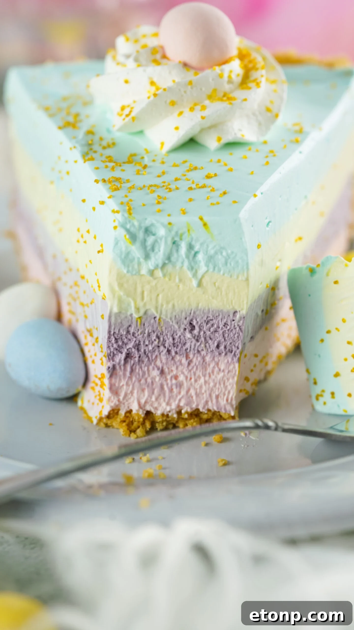 Front view of Easter Kool Aid Pie with a bite removed by a silver fork.