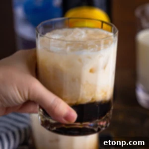 Classic White Russian cocktail with ice, vodka, coffee liqueur, and cream