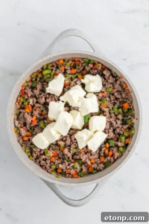 Philly Cheesesteak Casserole in a white dish, portioned out.