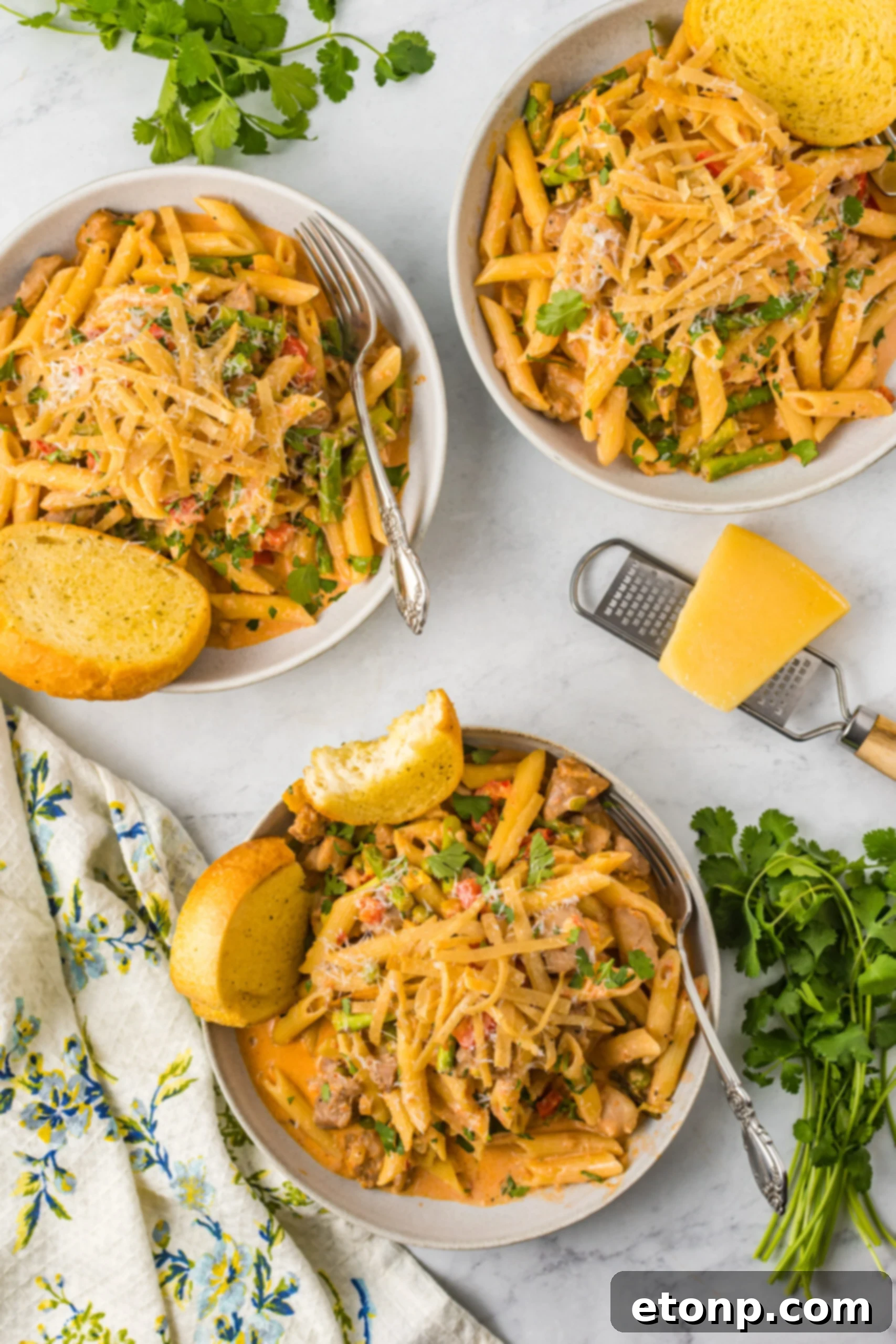 Overhead view of Cajun Chicken Pasta served in a dish with garlic bread.