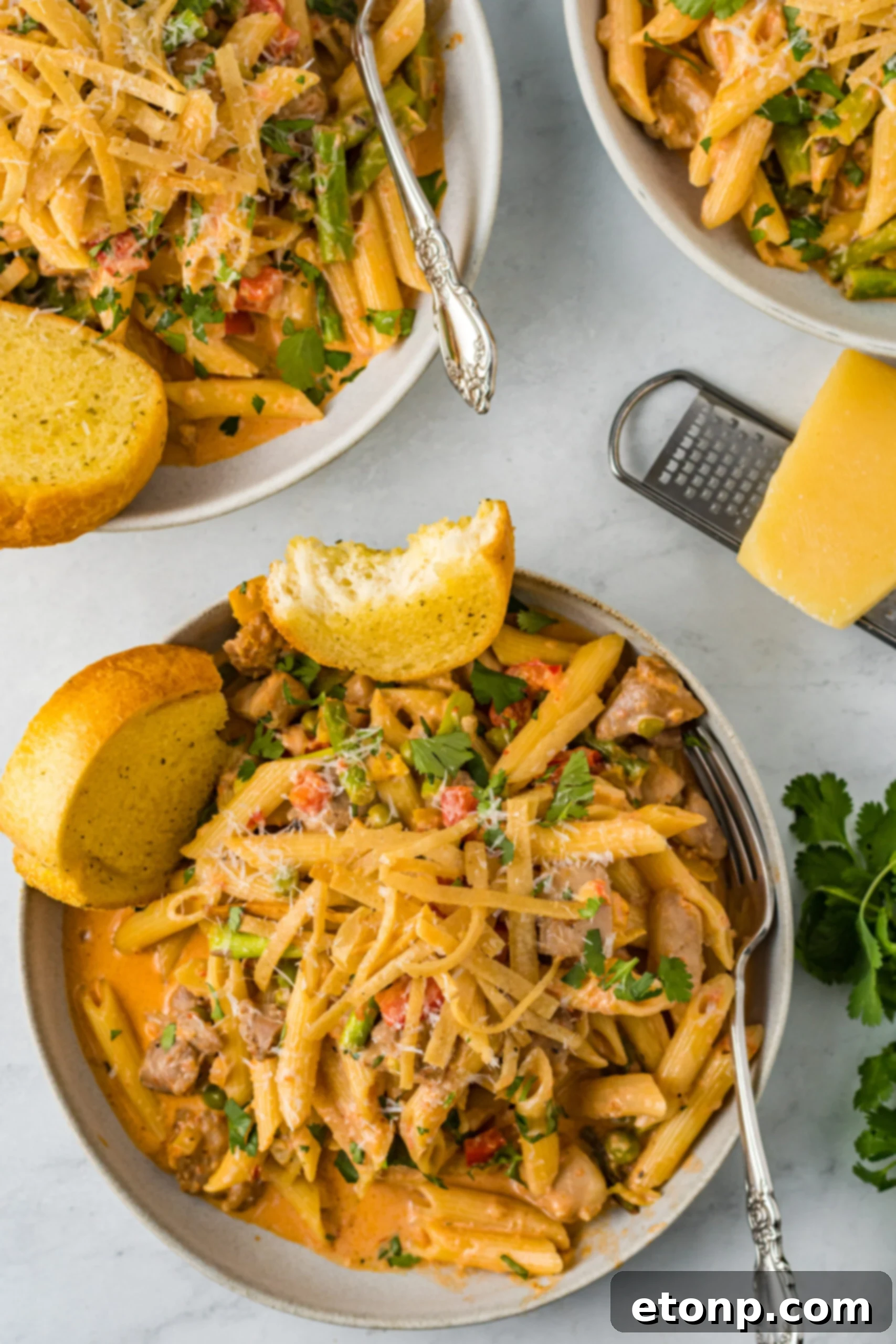 Overhead view of Cajun Chicken Pasta served in a dish with garlic bread.