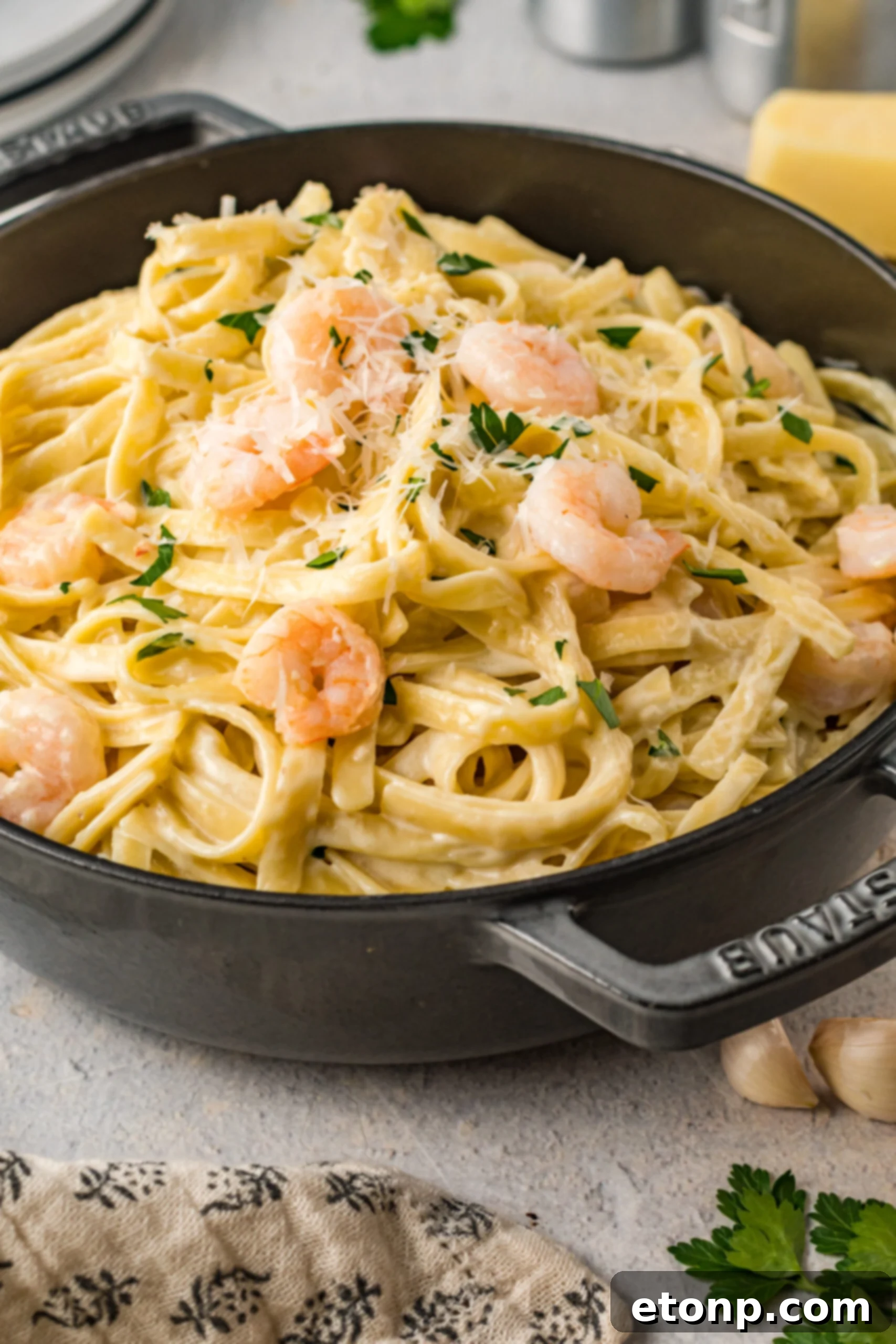 Front view of Shrimp Alfredo in a black cast iron pot.