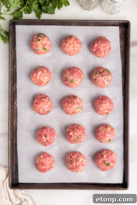Gooey Mozzarella Meatballs 13 Baking sheet of mozzarella stuffed meatballs, golden brown and freshly out of the oven.