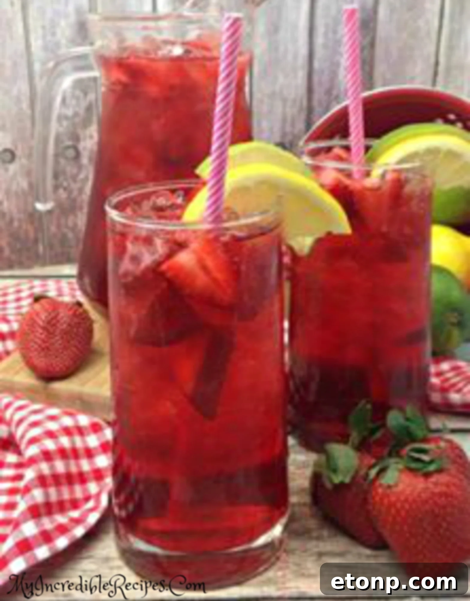 A beautifully set table with a pitcher and glasses of Southern Strawberry Sweet Tea.