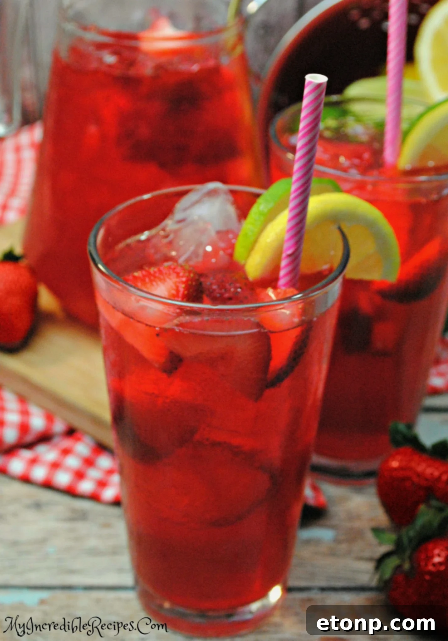 Ingredients for Southern Strawberry Sweet Tea laid out: fresh strawberries, lemons, limes, and tea bags.