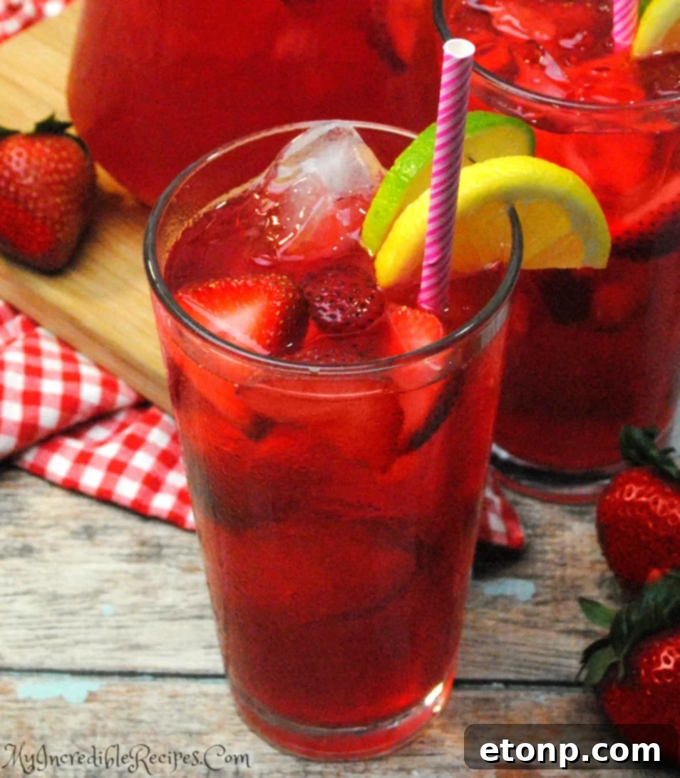 A pitcher of Southern Strawberry Sweet Tea in a refrigerator.