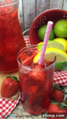 Fresh strawberries and tea bags on a wooden surface.