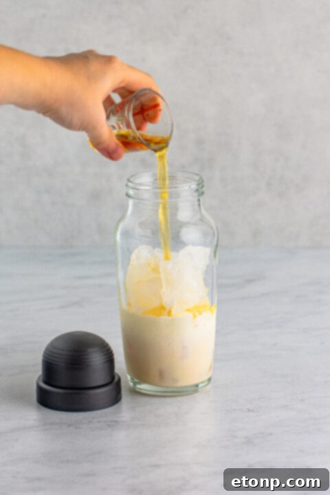 Step 3: Add heavy cream to the shaker.