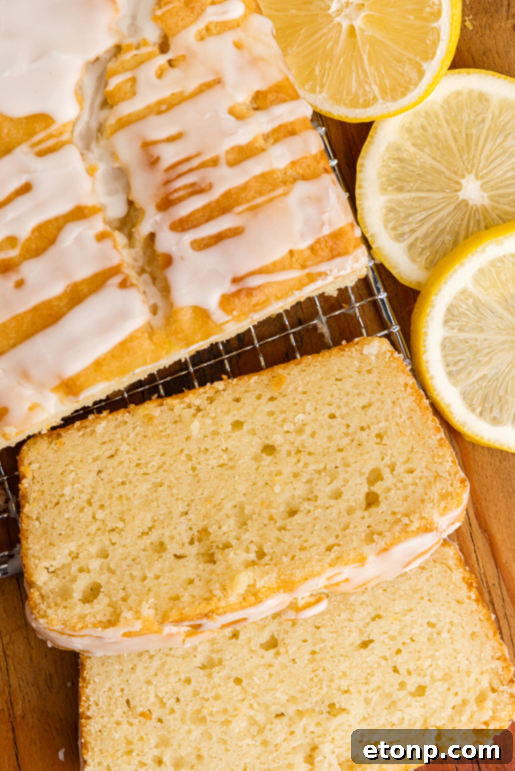 Overhead view of slices cut from a loaf of  Lemon Bread on a wire rack.