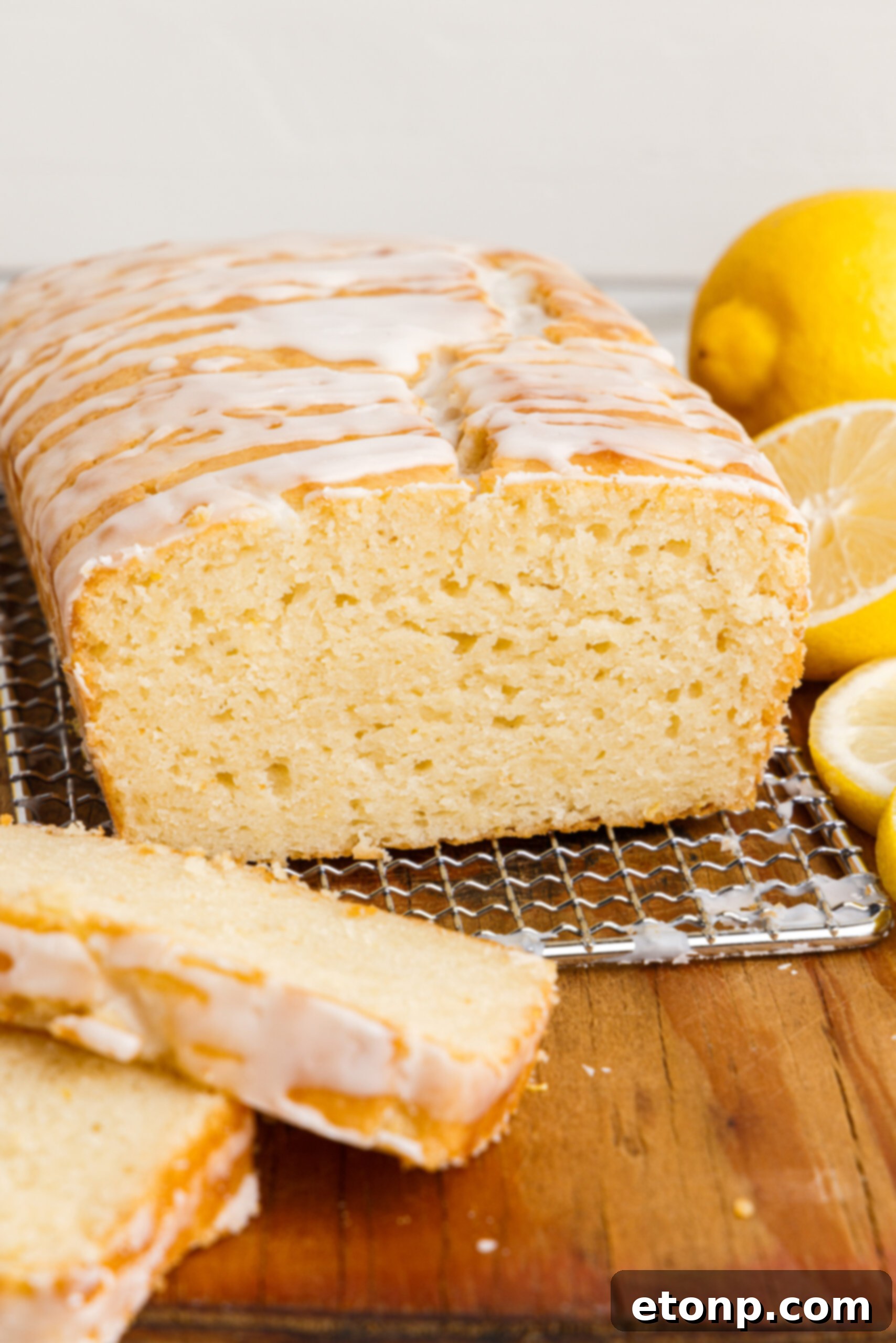 Front view of  Lemon Bread on a wire rack with slices removed.