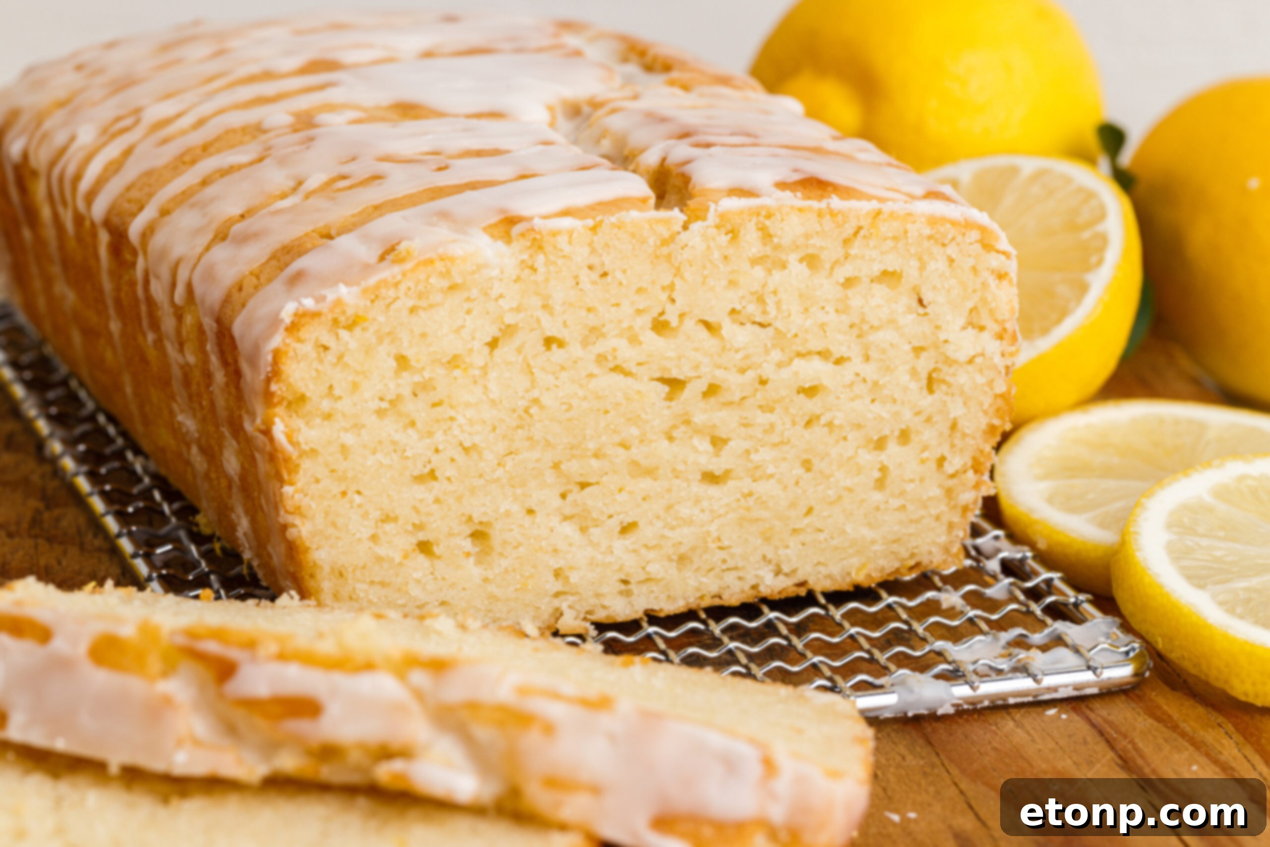 Front view of  Lemon Bread on a wire rack with slices removed.