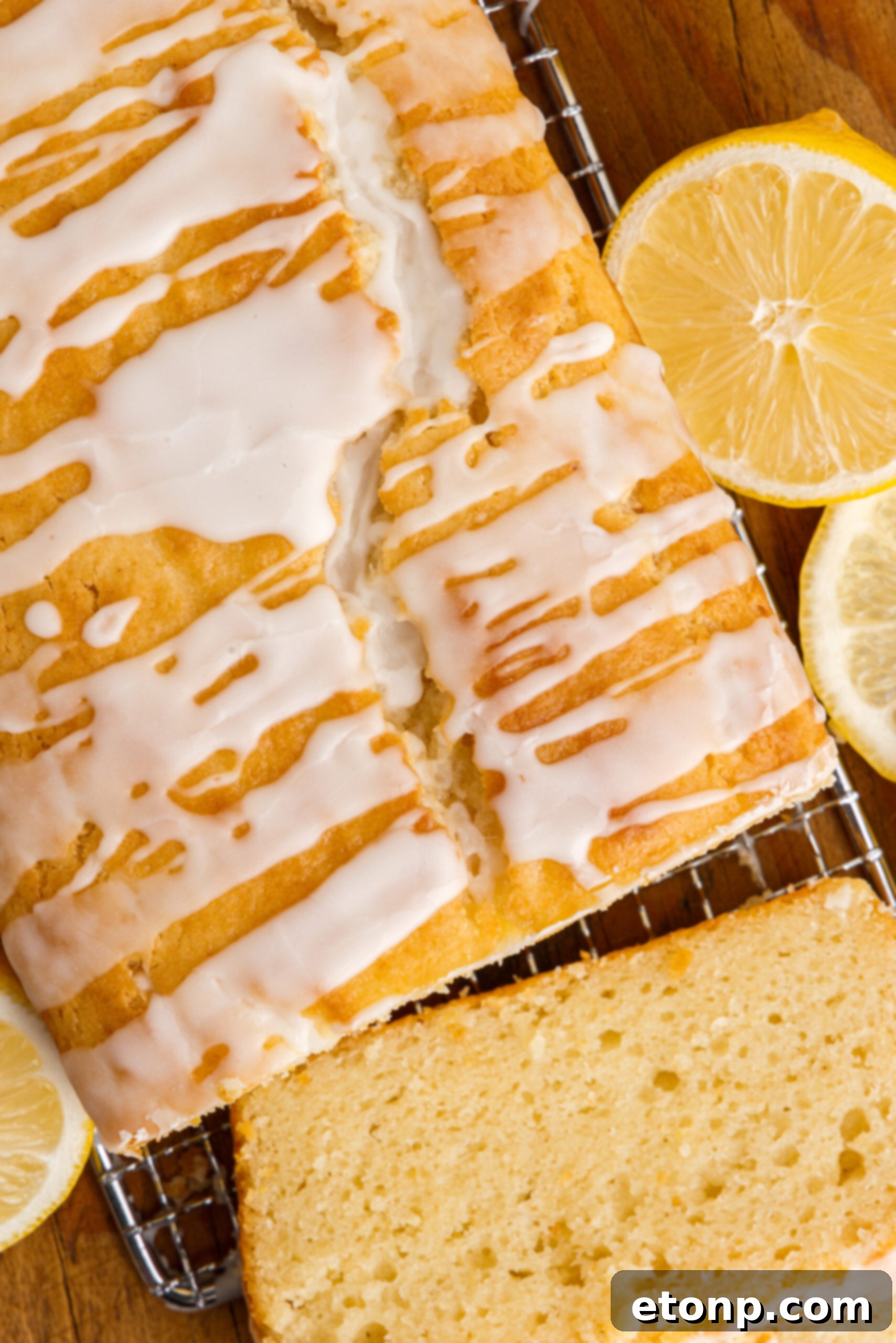 Overhead view of slices cut from a loaf of  Lemon Bread on a wire rack.