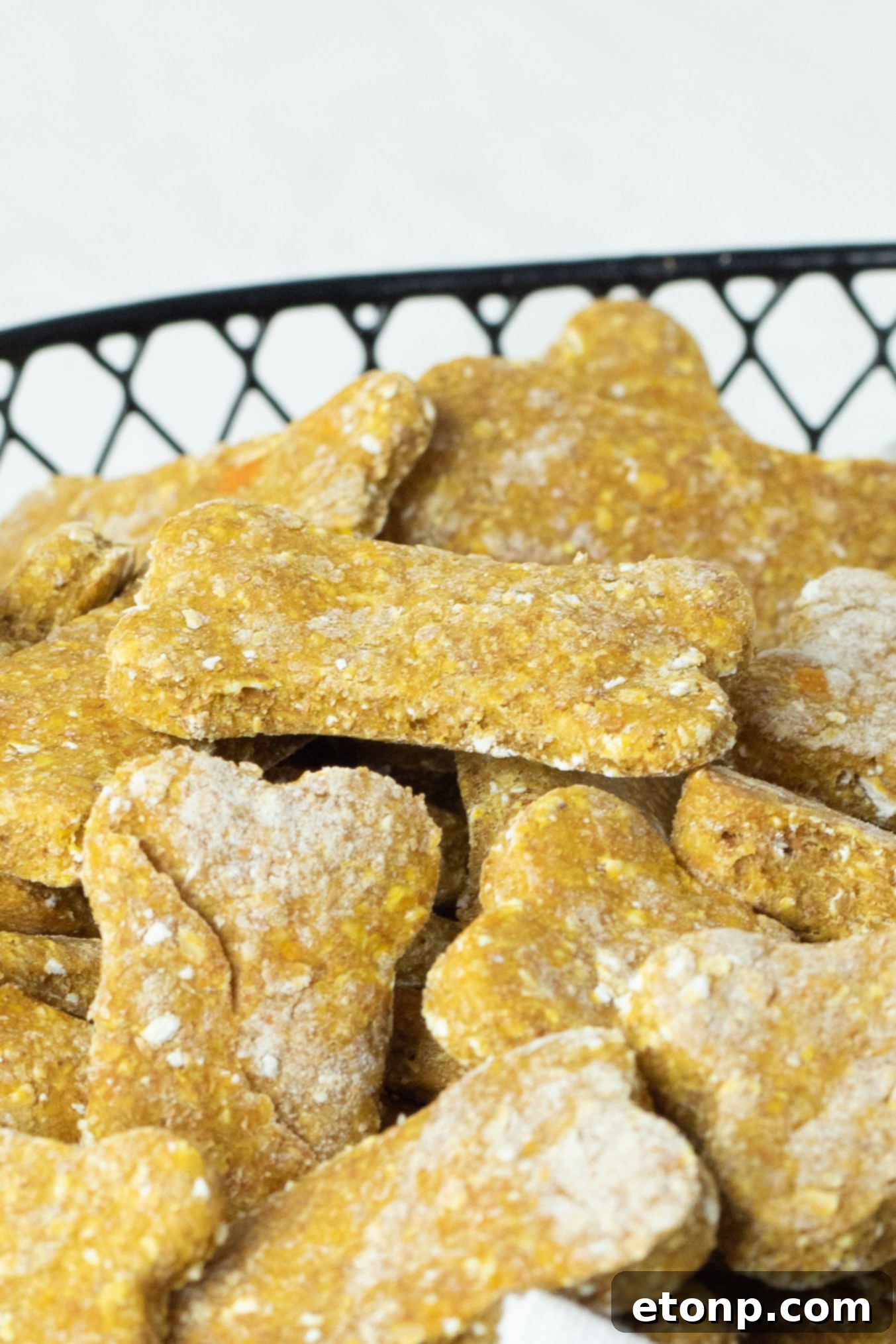 An inviting view of the Sweet Potato and Pumpkin Dog Treats, emphasizing their natural ingredients and homemade charm, nestled comfortably in a linen-lined basket.