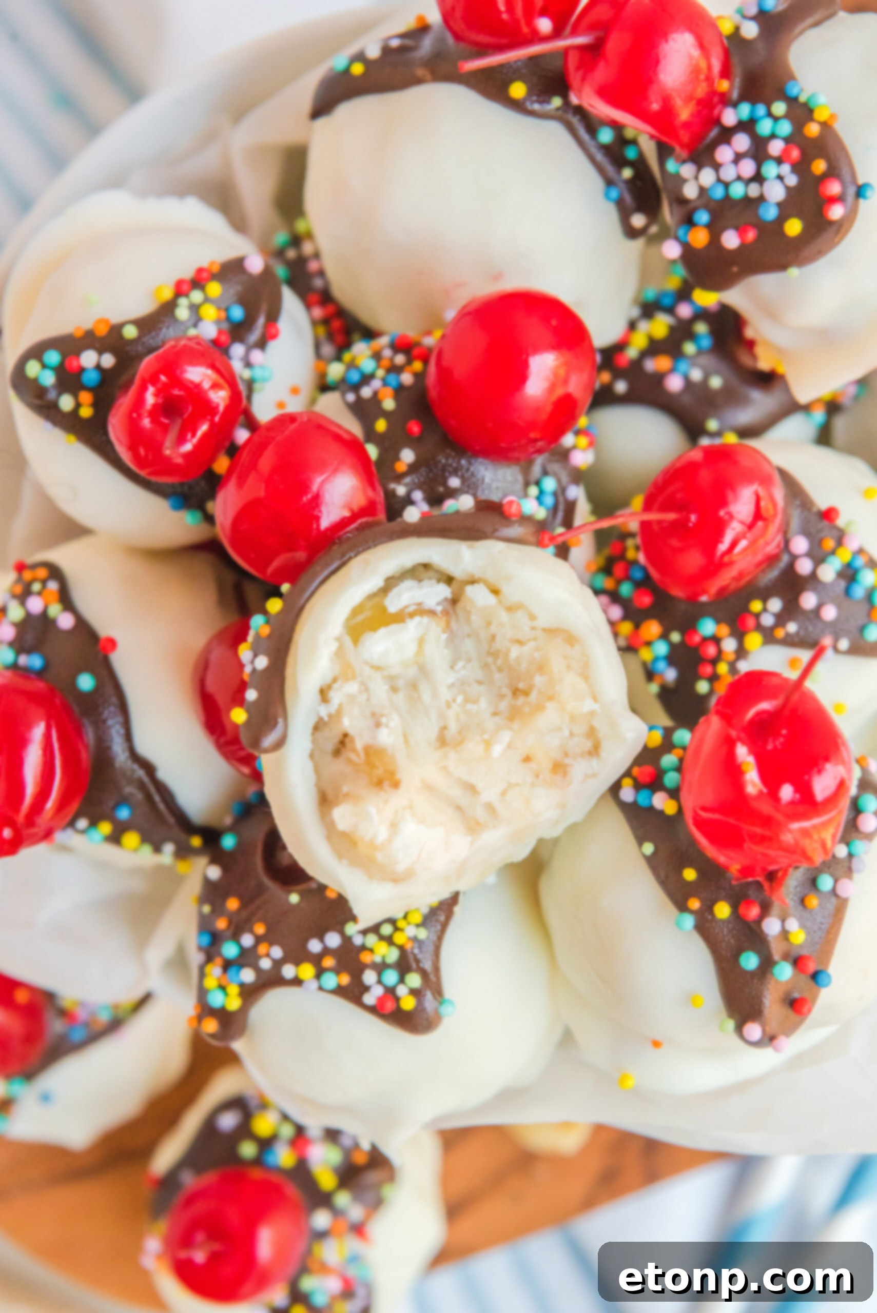 Overhead view of Banana Truffles stacked in a dish with a bit removed from the top truffle. 