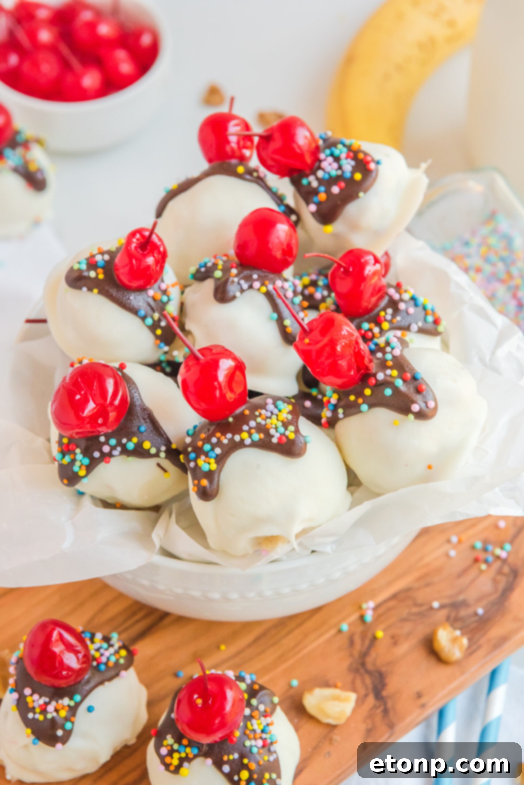 Overhead view of Banana Truffles surrounded by cherries, nuts, and bananas.