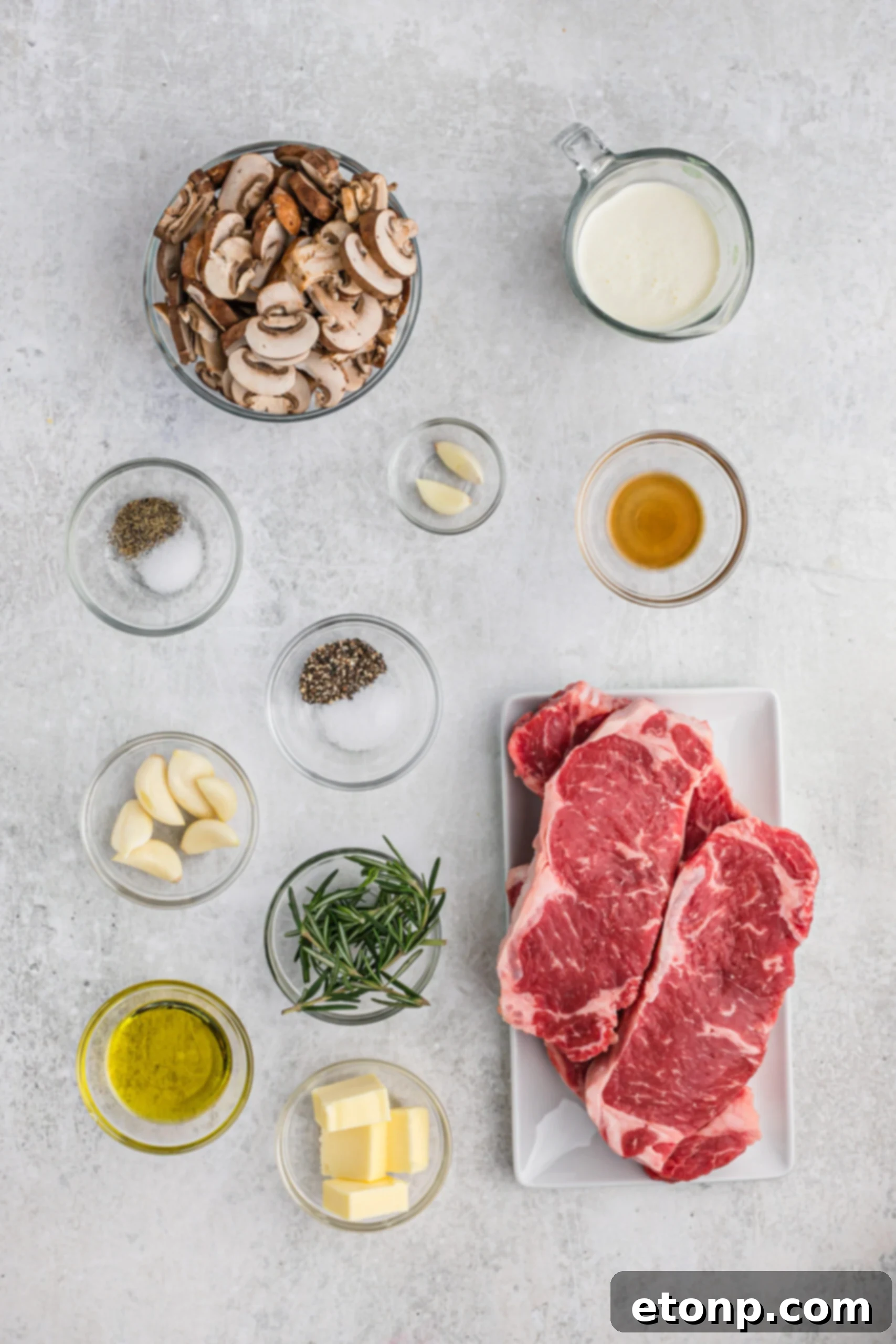 Ultimate Garlic Butter Steak 5 Overhead view displaying all the fresh, high-quality ingredients neatly arranged on a counter, ready for preparing the Garlic Butter Steak recipe.