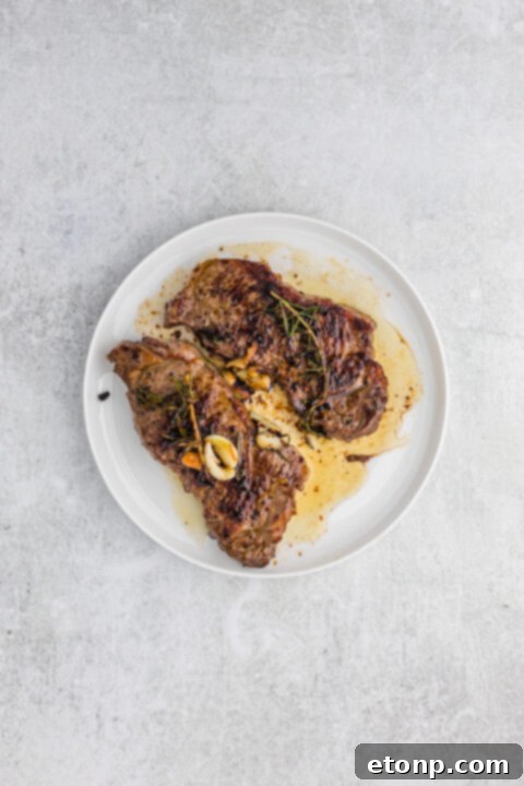 Ultimate Garlic Butter Steak 9 Mushrooms sautéing in a pan with pan juices for the sauce.
