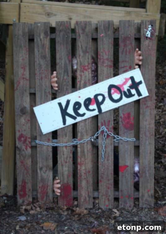 Creepy Halloween pallet idea with hands coming out of the ground