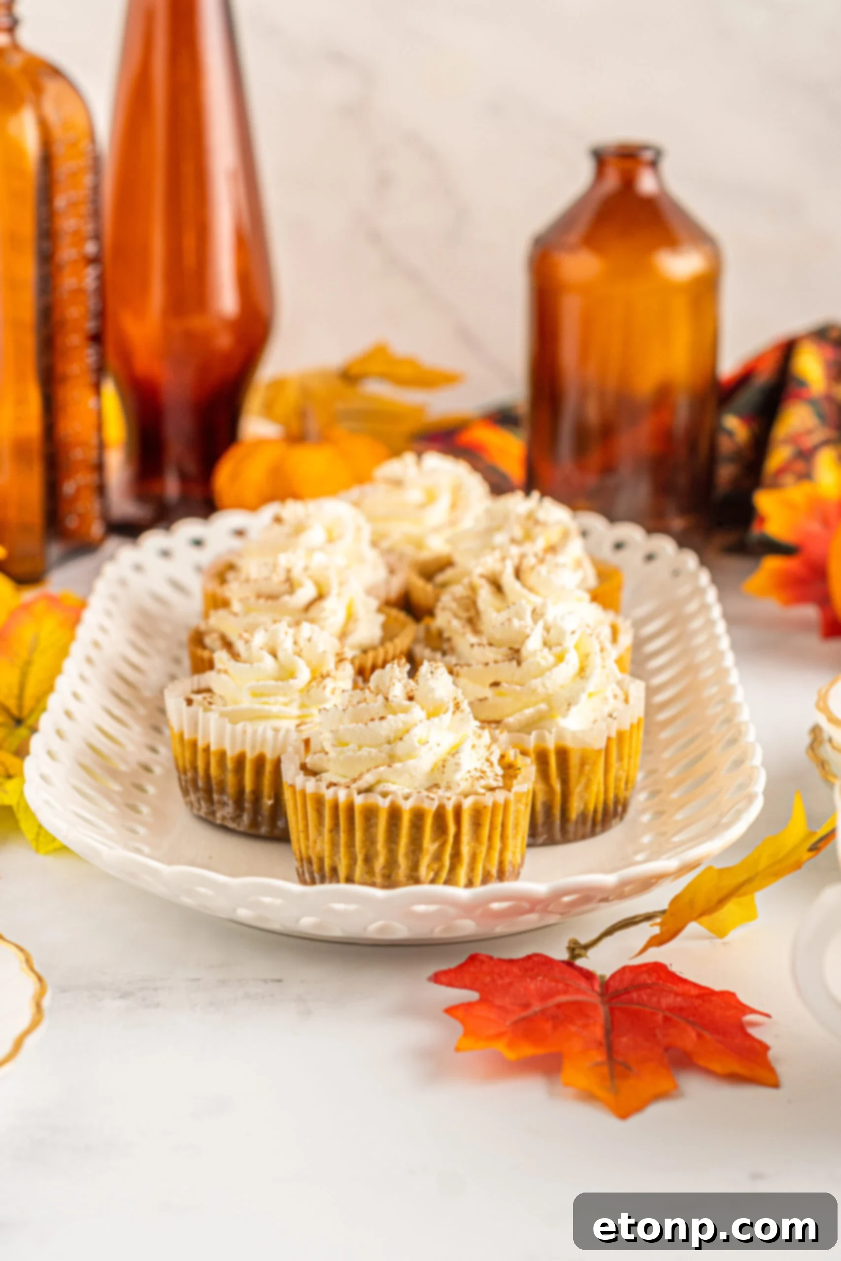 Close-up front view of delicious Mini Pumpkin Cheesecakes, ready to be enjoyed.