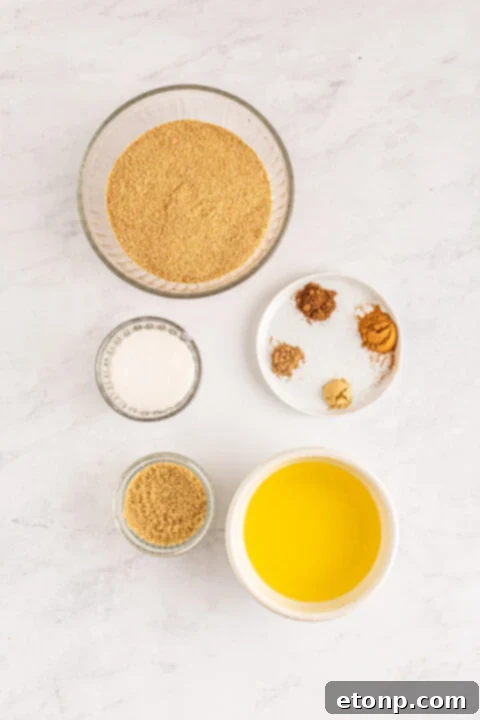 Various baking ingredients for pumpkin cheesecakes laid out, including spices and a measuring cup.
