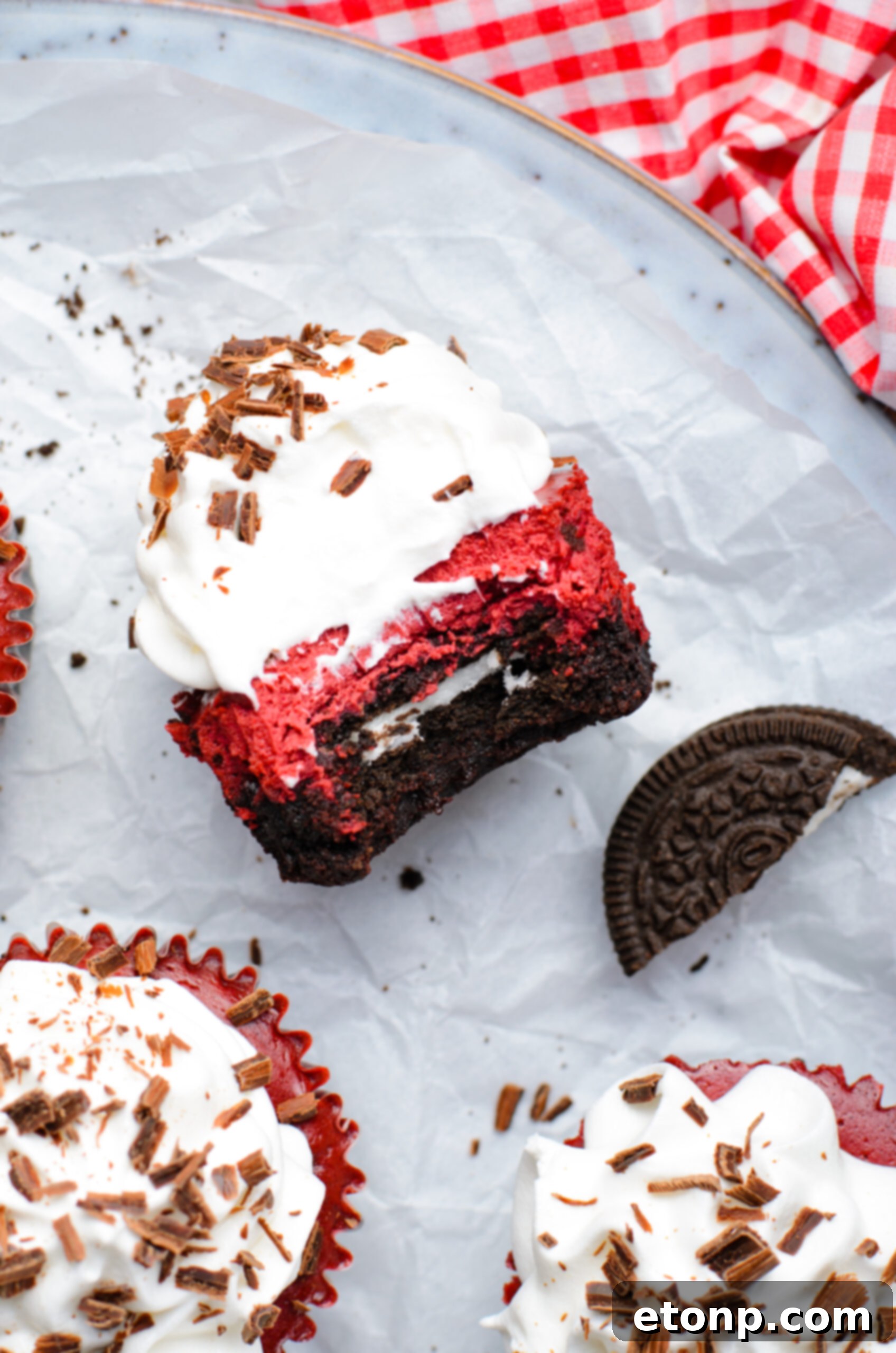 Overhead view of a Mini Red Velvet Oreo Cheesecake on its side with a bite removed.