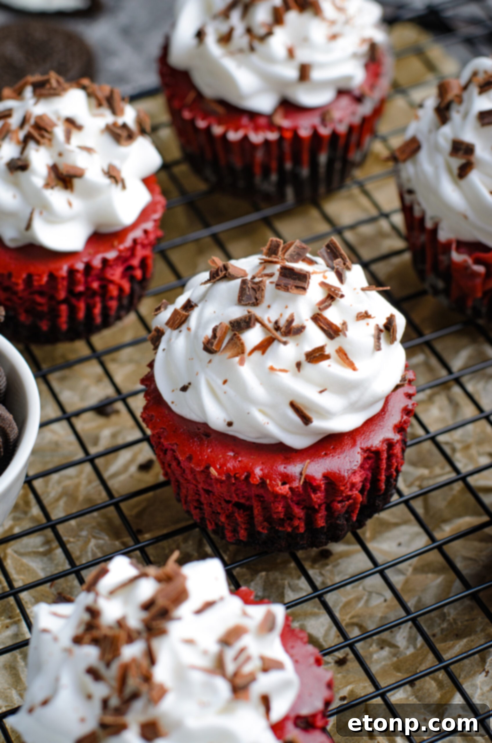Close up view of Mini Red Velvet Oreo Cheesecakes on a back wire rack.