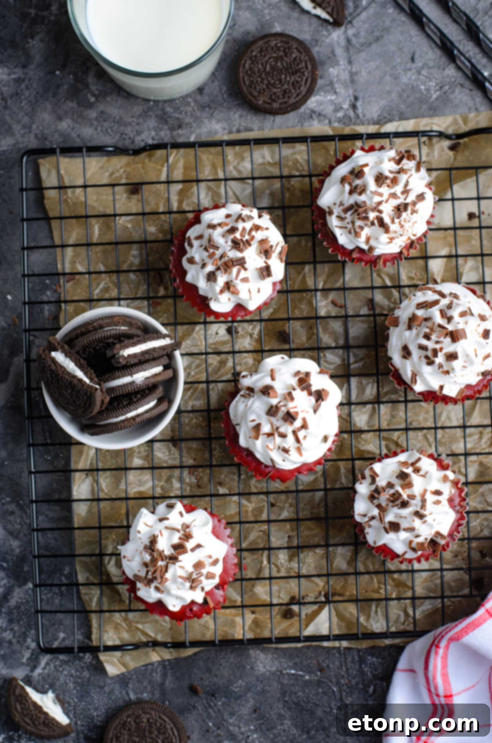 Overhead view of Mini Red Velvet Oreo Cheesecakes on a black wire rack.