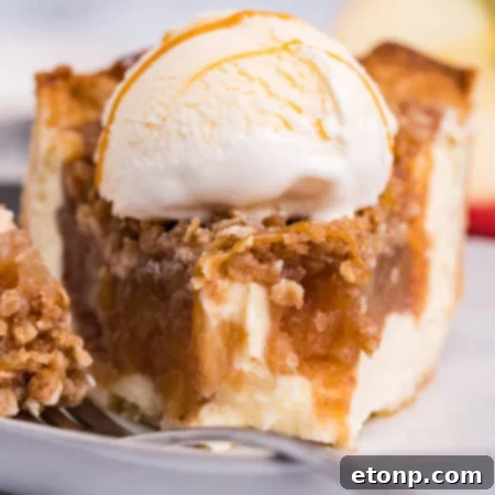 Apple Crumb Cheesecake Pie with a slice removed