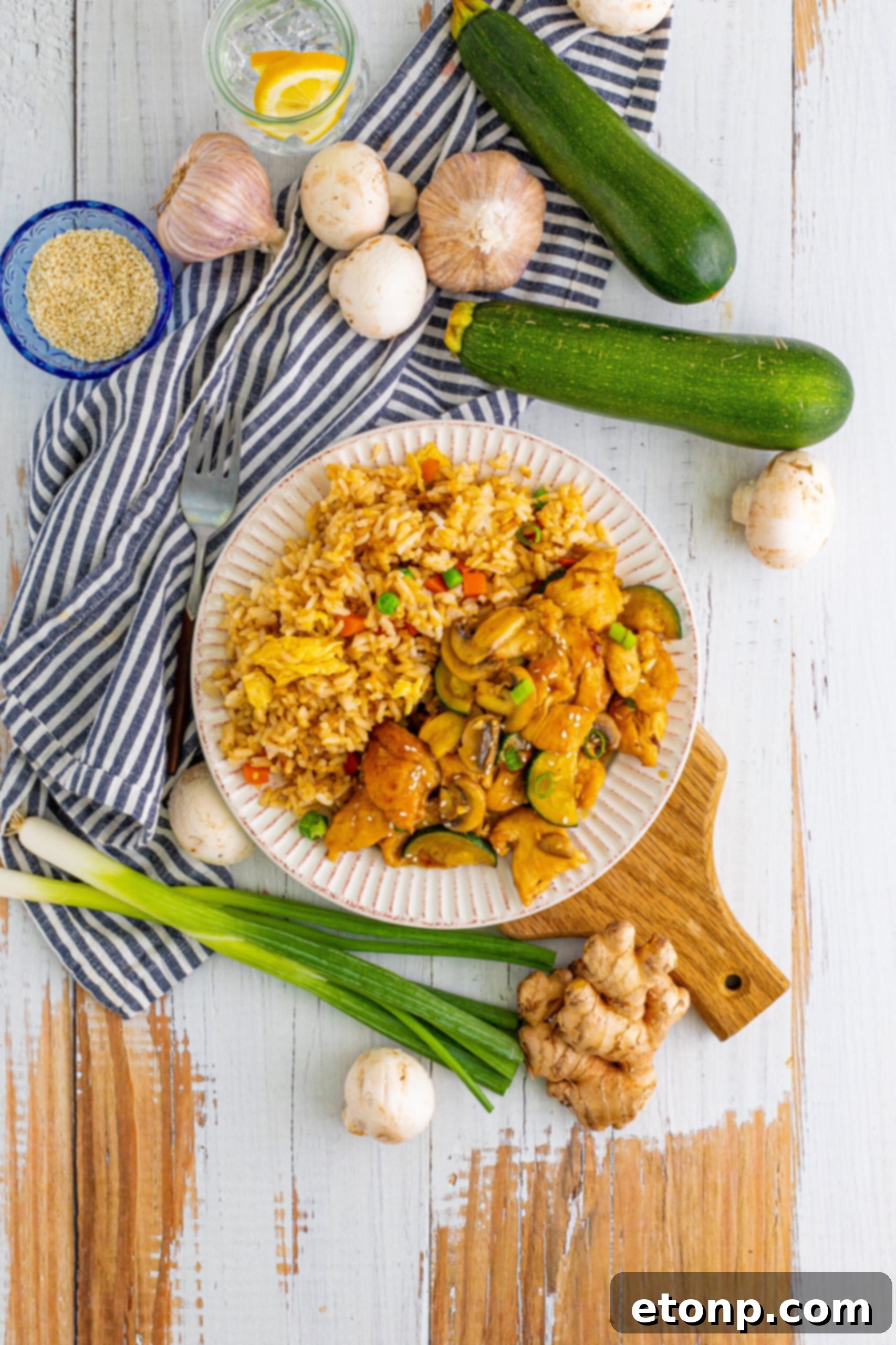 Overhead view of Panda Express Mushroom Chicken on a white dish served with fried rice.