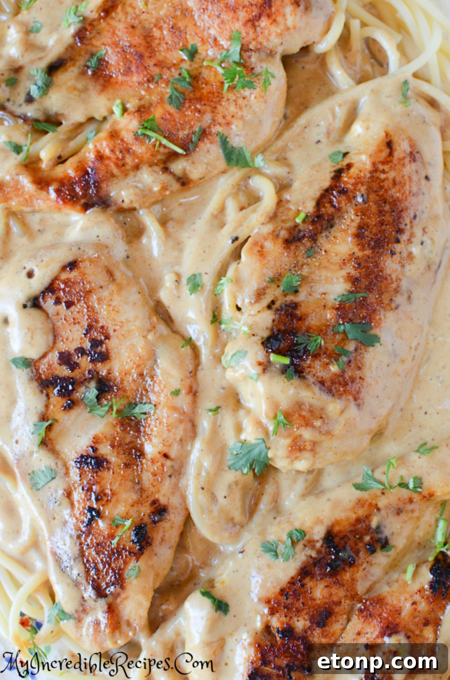 Close-up of chicken and sauce simmering in a pan