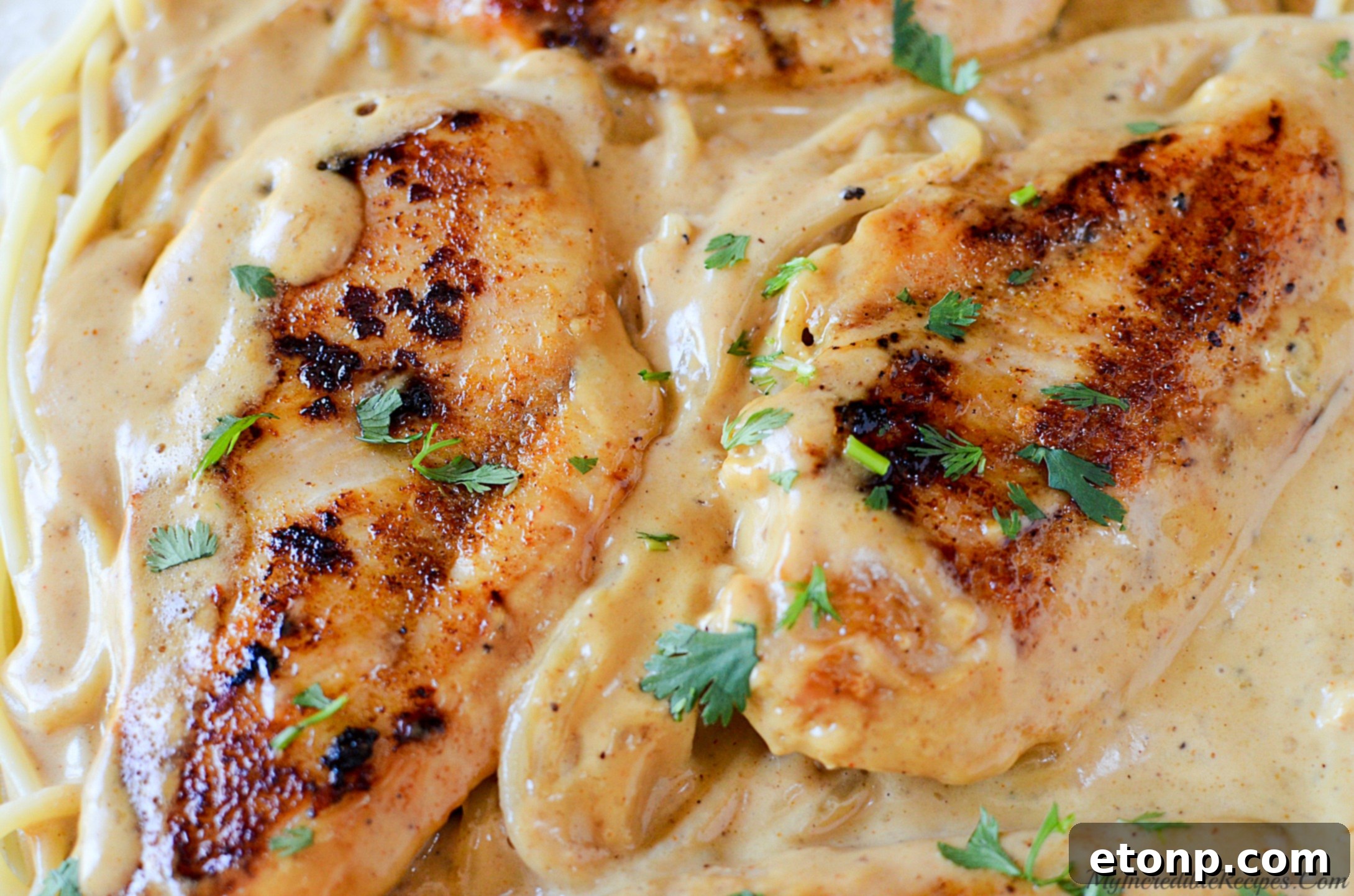 Finished Chicken Lazone served over pasta in a skillet