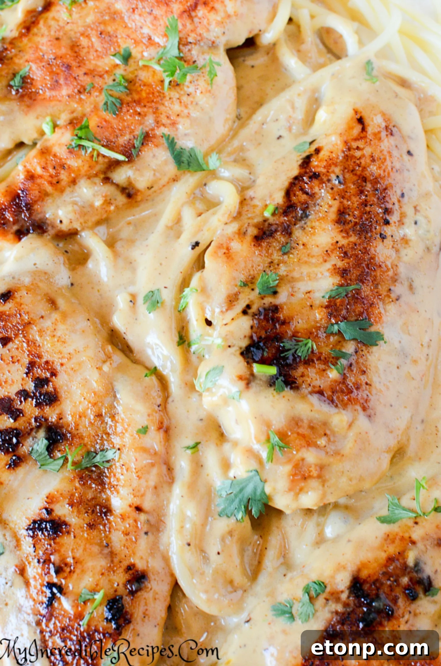 Hand sprinkling seasoning on chicken pieces
