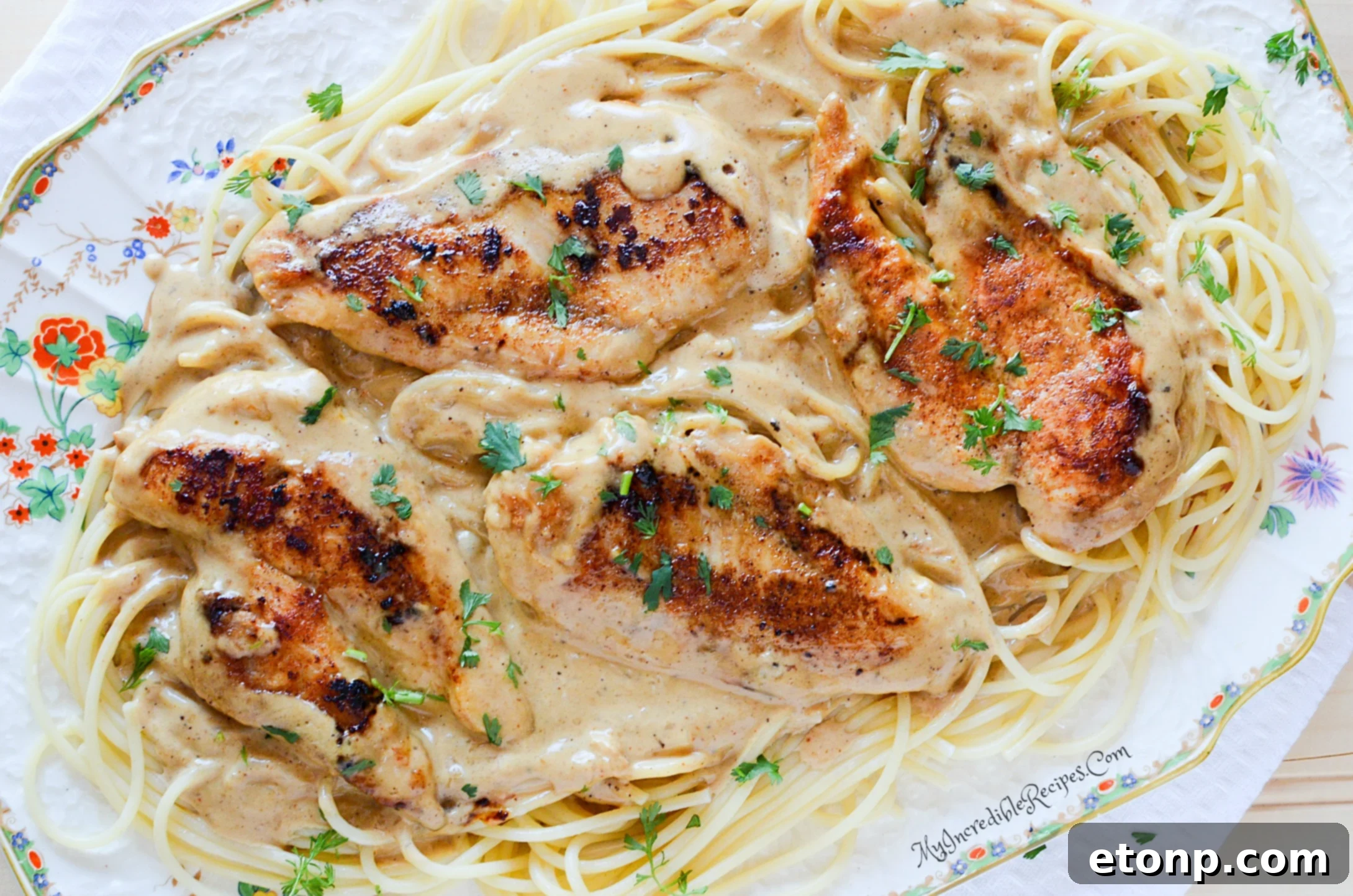 Cook tasting the Chicken Lazone sauce from the skillet
