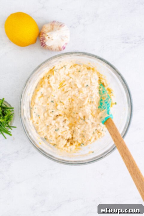 Decadent Crab Delight 10 Crab dip being scooped onto a cracker